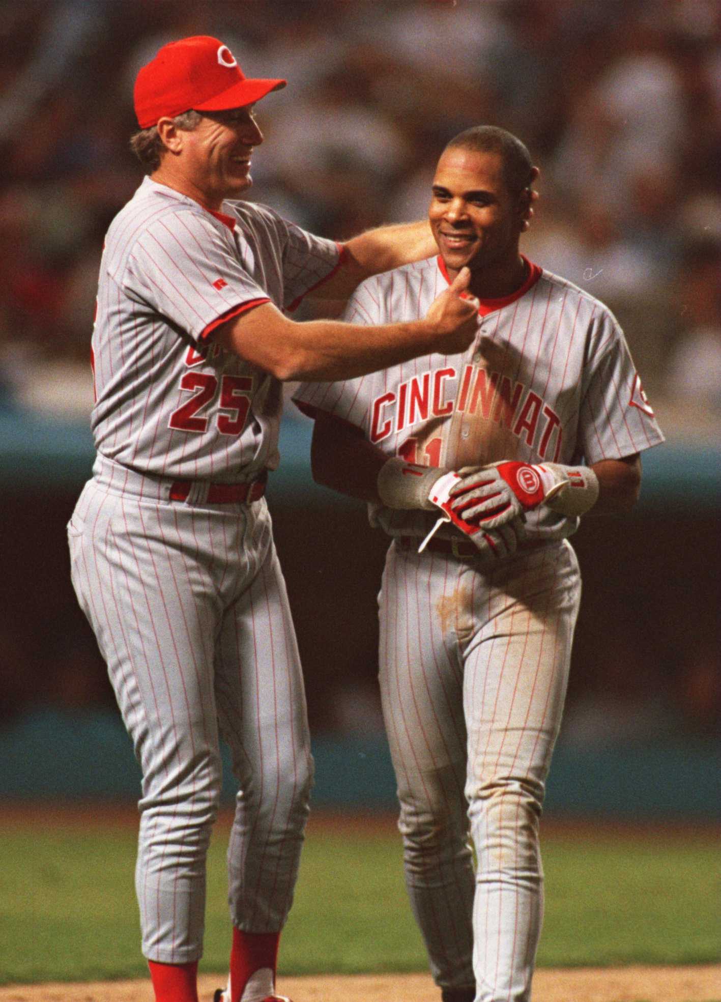 4 OCT 1995:  CINCINNATI REDS INFIELDER BARRY LARKIN SMILES WITH ASSISTANT COACH RAY KNIGHT (LEFT) AFTER HITTING A SINGLE WHICH DROVE IN THE 3RD RUN FOR THE REDS DURING THEIR 5-4 NATIONAL LEAGUE PLAYOFF WIN OVER THE LOS ANGELES DODGERS AT DODGER STADIUM IN