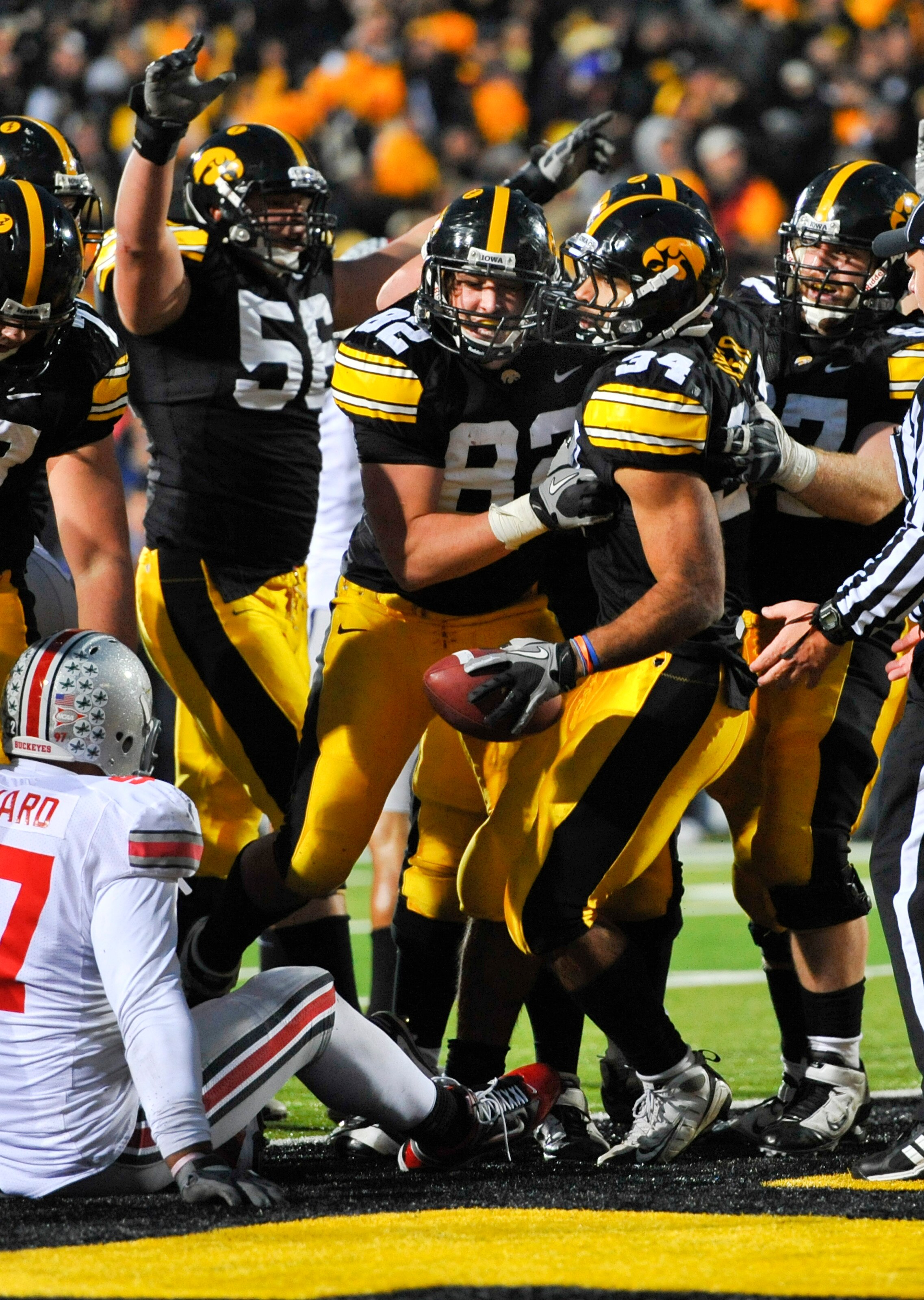 IOWA CITY, IA - NOVEMBER 20: Running back Marcus Coker #34 of the University of Iowa Hawkeyes celebrates with his teammates after scoring a touchdown against the Ohio State Buckeyes during the second half of play at Kinnick Stadium on November 20, 2010 in