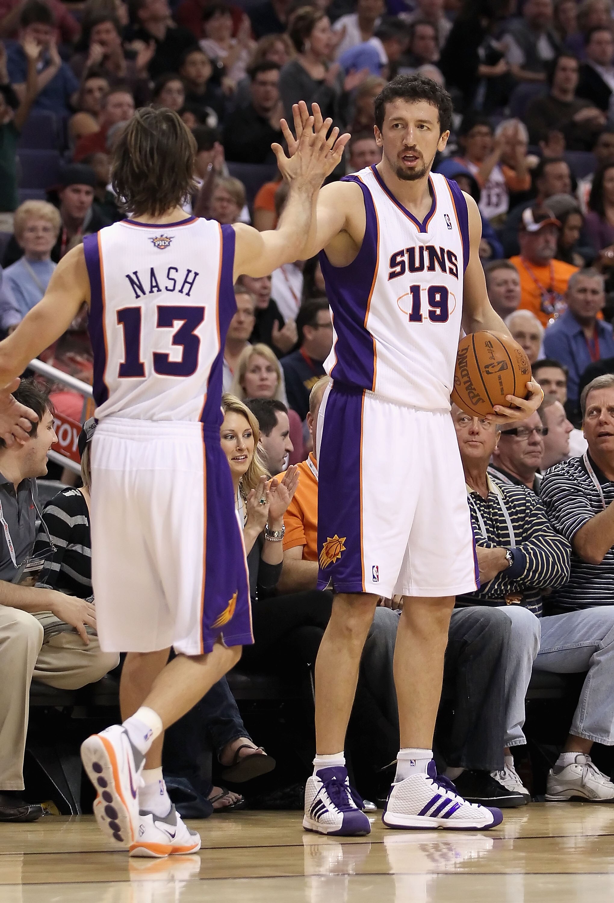 PHOENIX - NOVEMBER 15:  Hedo Turkoglu #19 of the Phoenix Suns high fives teammate Steve Nash #13 during the NBA game against the Denver Nuggets at US Airways Center on November 15, 2010 in Phoenix, Arizona. The Suns defeated the Nuggets 100-94. NOTE TO US