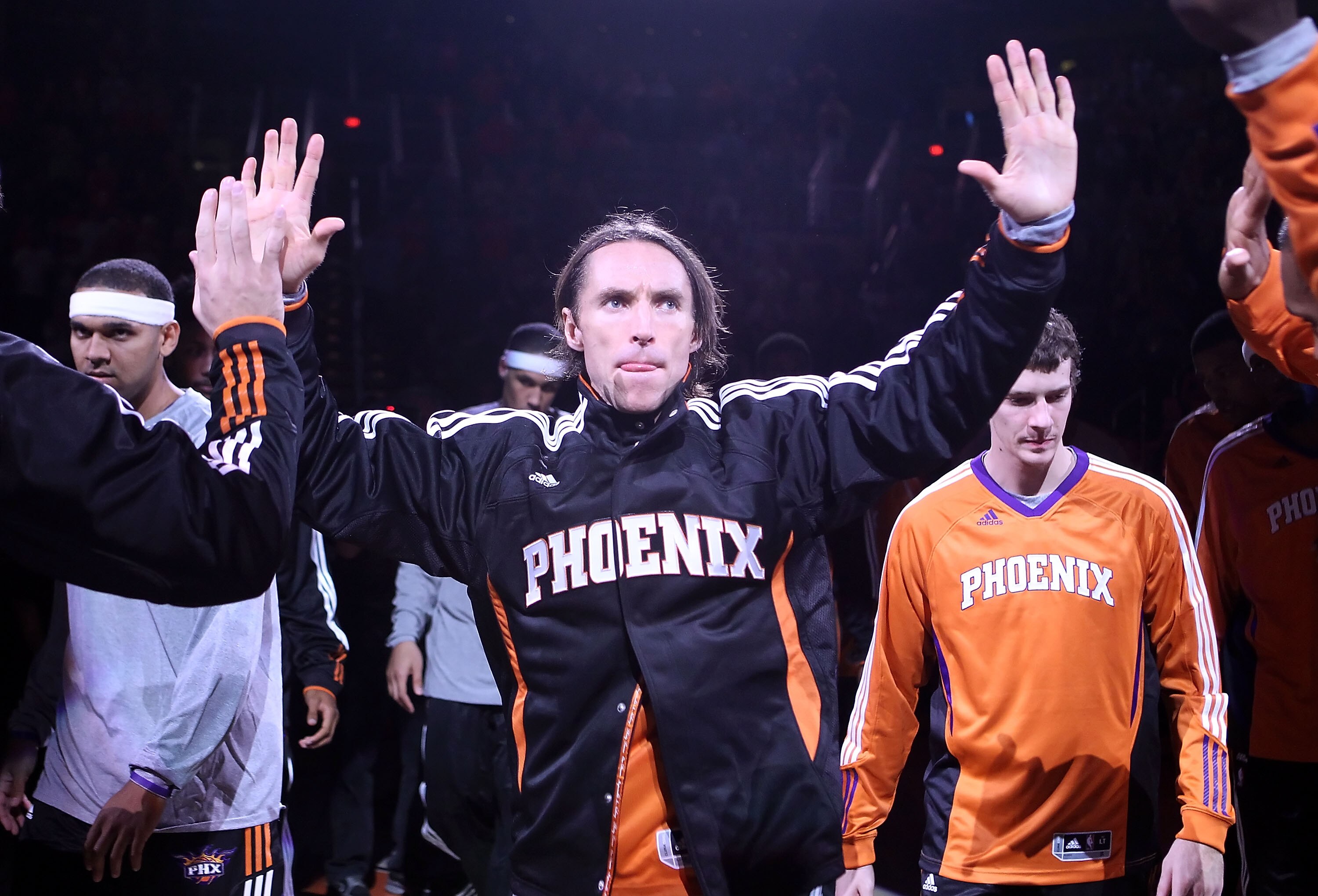 PHOENIX - OCTOBER 12:  Steve Nash #13 of the Phoenix Suns high fives teamamtes as he is introduced before the preseason NBA game against the Utah Jazz at US Airways Center on October 12, 2010 in Phoenix, Arizona. NOTE TO USER: User expressly acknowledges