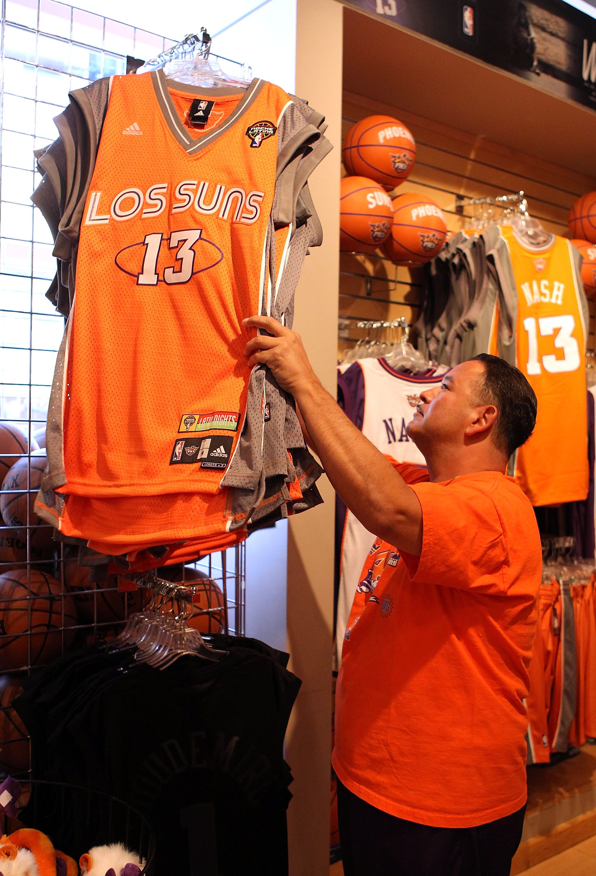 PHOENIX - MAY 05:  Phoenix Suns fan Marc Lyles purchases a 'Los Suns' jersey before Game Two of the Western Conference Semifinals of the 2010 NBA Playoffs against the San Antonio Spurs at US Airways Center on May 5, 2010 in Phoenix, Arizona. The team is w