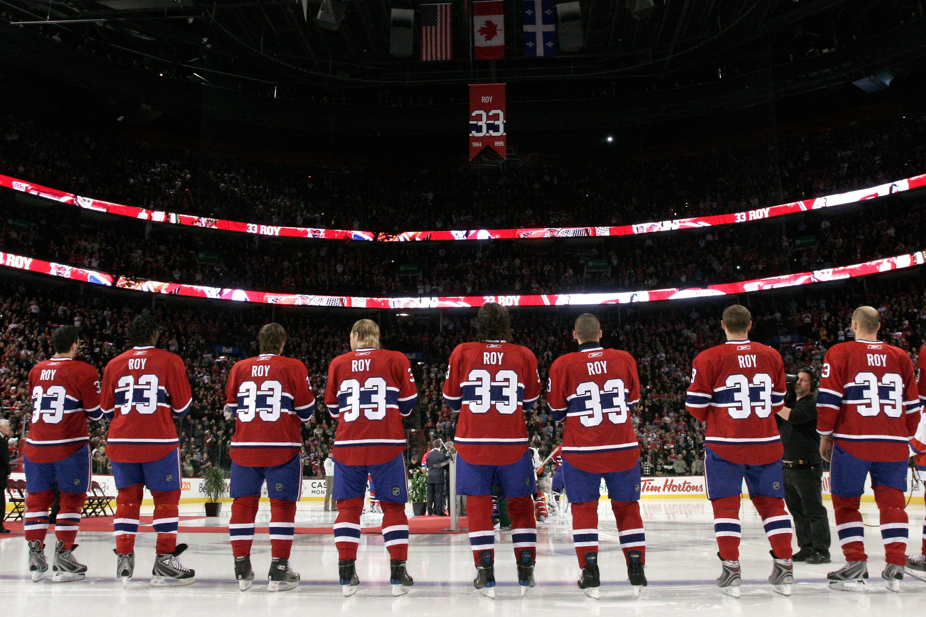 MONTREAL- NOVEMBER 22:   Members of the Montreal Canadiens stand watching the #33 banner of Patrick Roy being hoisted to the rafters during  the retirement ceremony before the game against the Boston Bruins at the Bell Centre on November 22, 2008 in Montr