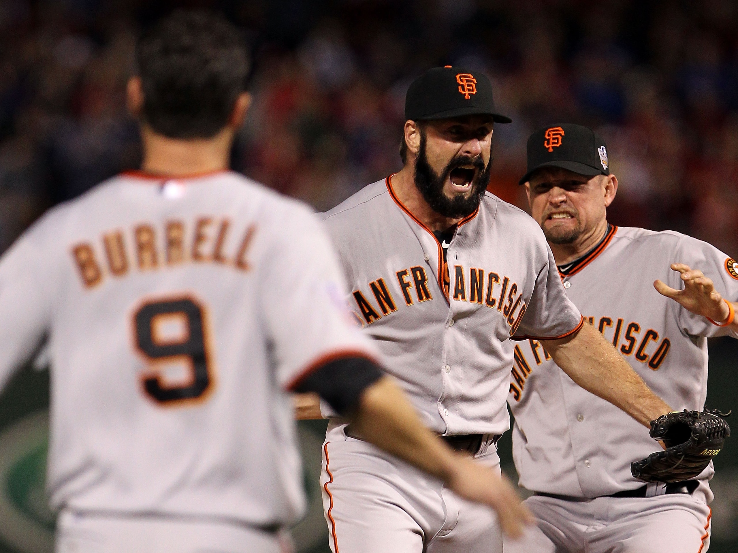 ARLINGTON, TX - NOVEMBER 01:  Brian Wilson (C) #38, Aubrey Huff #17 (R) and Pat Burrell #9 of  the San Francisco Giants celebrate on the field after the Giants won 3-1 against the Texas Rangers in Game Five of the 2010 MLB World Series at Rangers Ballpark