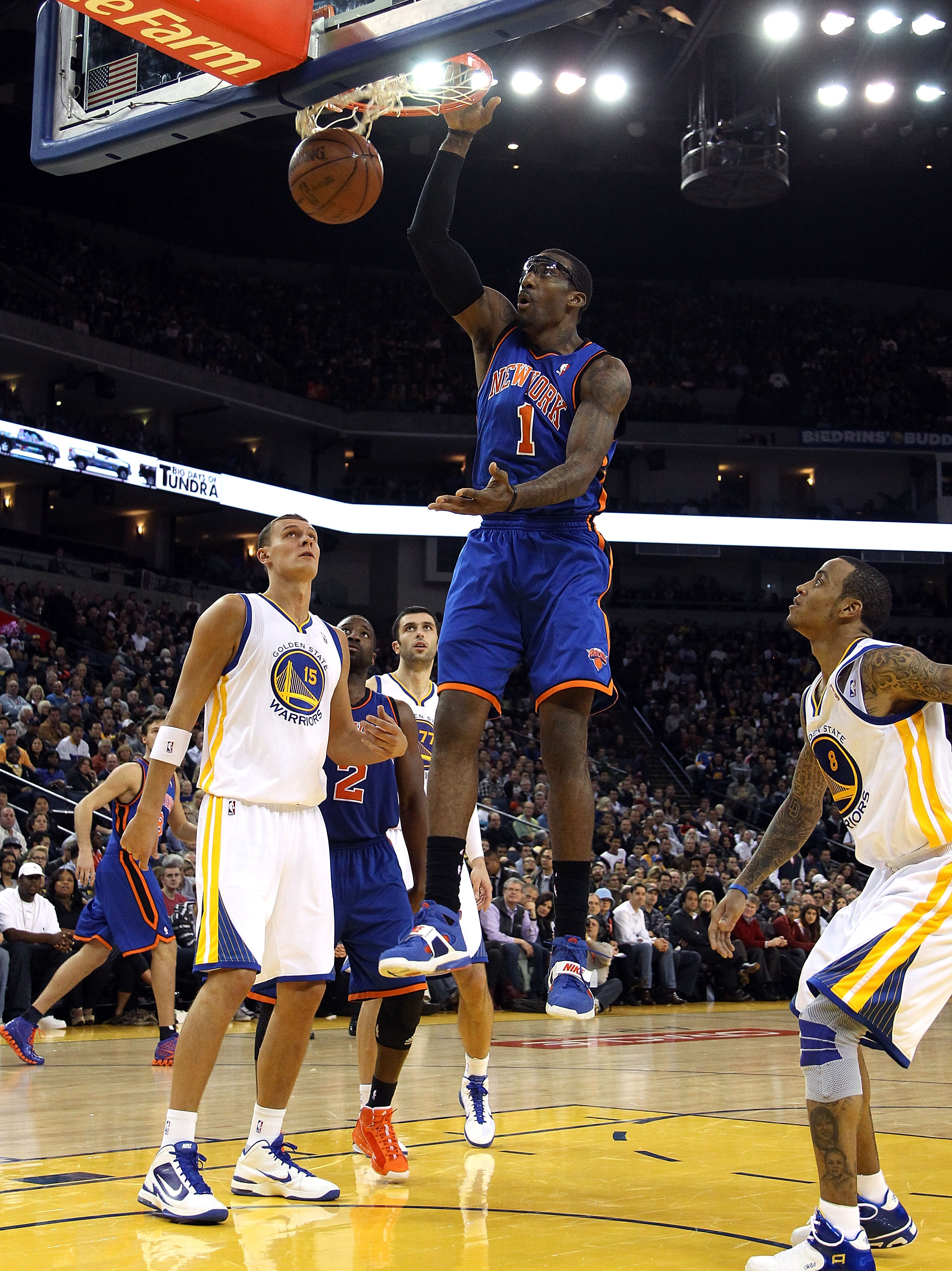 OAKLAND, CA - NOVEMBER 19:  Amar'e Stoudemire #1 of the New York Knicks dunks the ball over Andris Biedrins #15 of the Golden State Warriors at Oracle Arena on November 19, 2010 in Oakland, California. NOTE TO USER: User expressly acknowledges and agrees