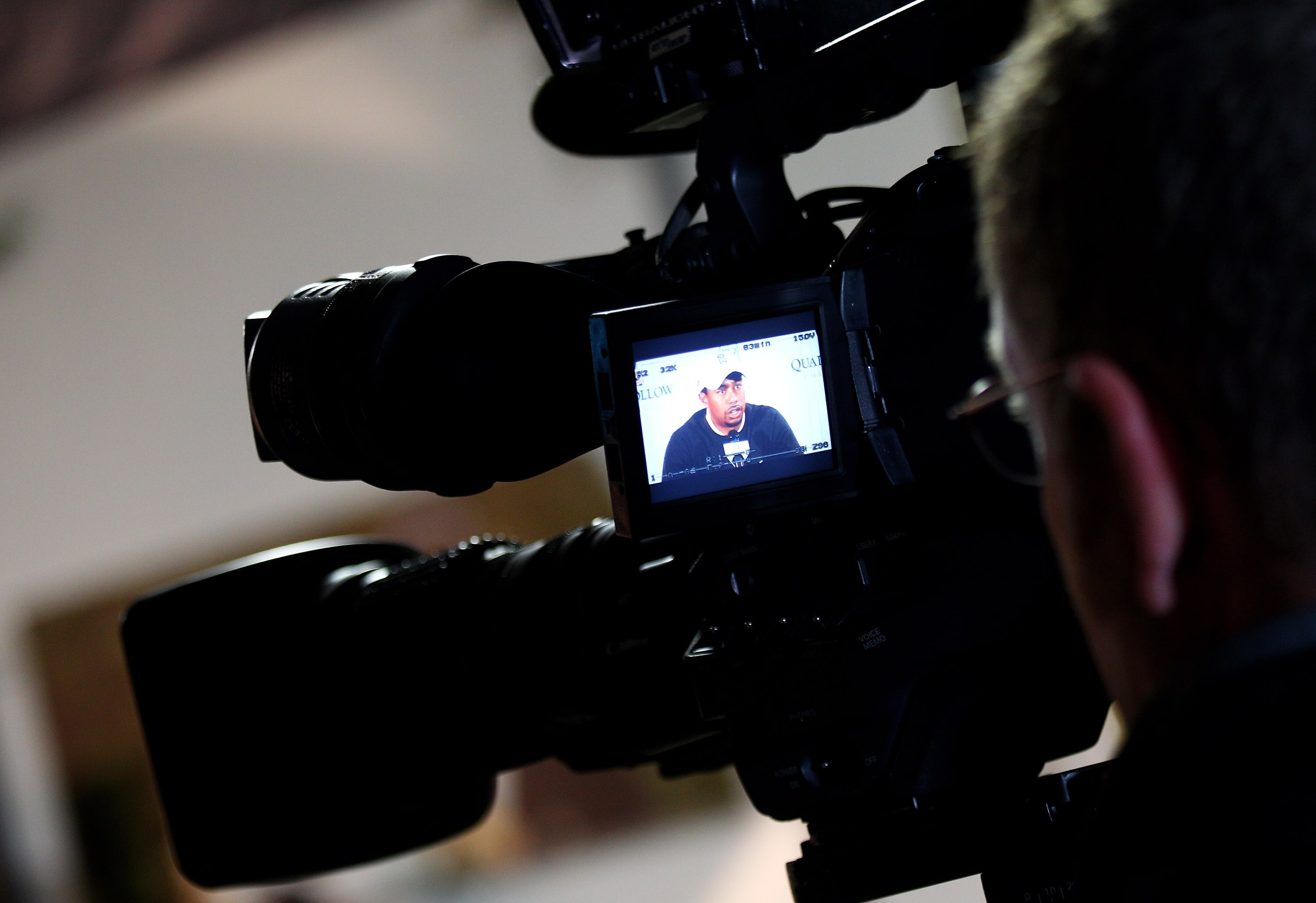 CHARLOTTE, NC - APRIL 28:  Tiger Woods is seen through the viewfinder of a TV camera as he speaks to the media in a press conference during the pro-am for the Quail Hollow Championship at Quail Hollow Country Club on April 28, 2010 in Charlotte, North Car