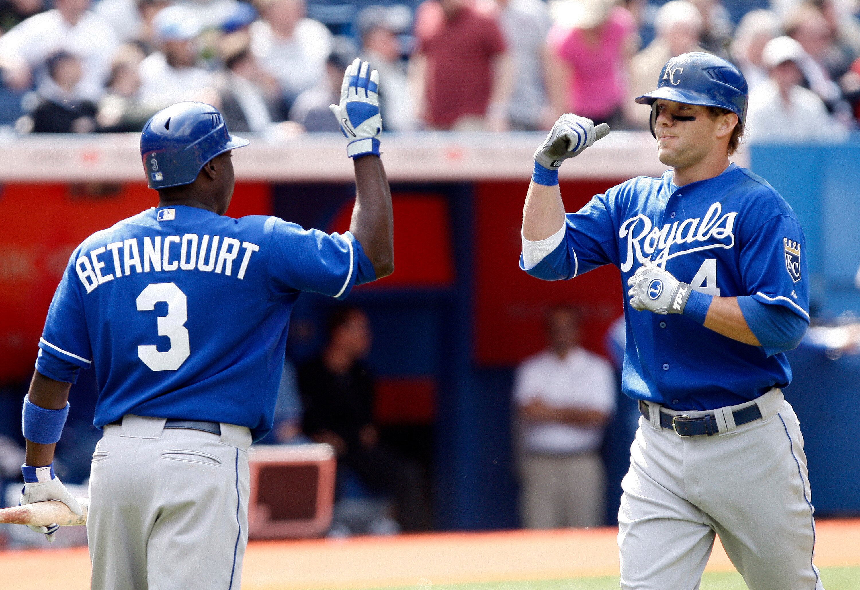 TORONTO - APRIL 21: Alex Gordon #4 of the Kansas City Royals celebrates his 10th inning home run with Yuniesky Betancourt #3 during a MLB game against the Toronto Blue Jays at the Rogers Centre April 21, 2010 in Toronto, Ontario, Canada. (Photo by Abelima