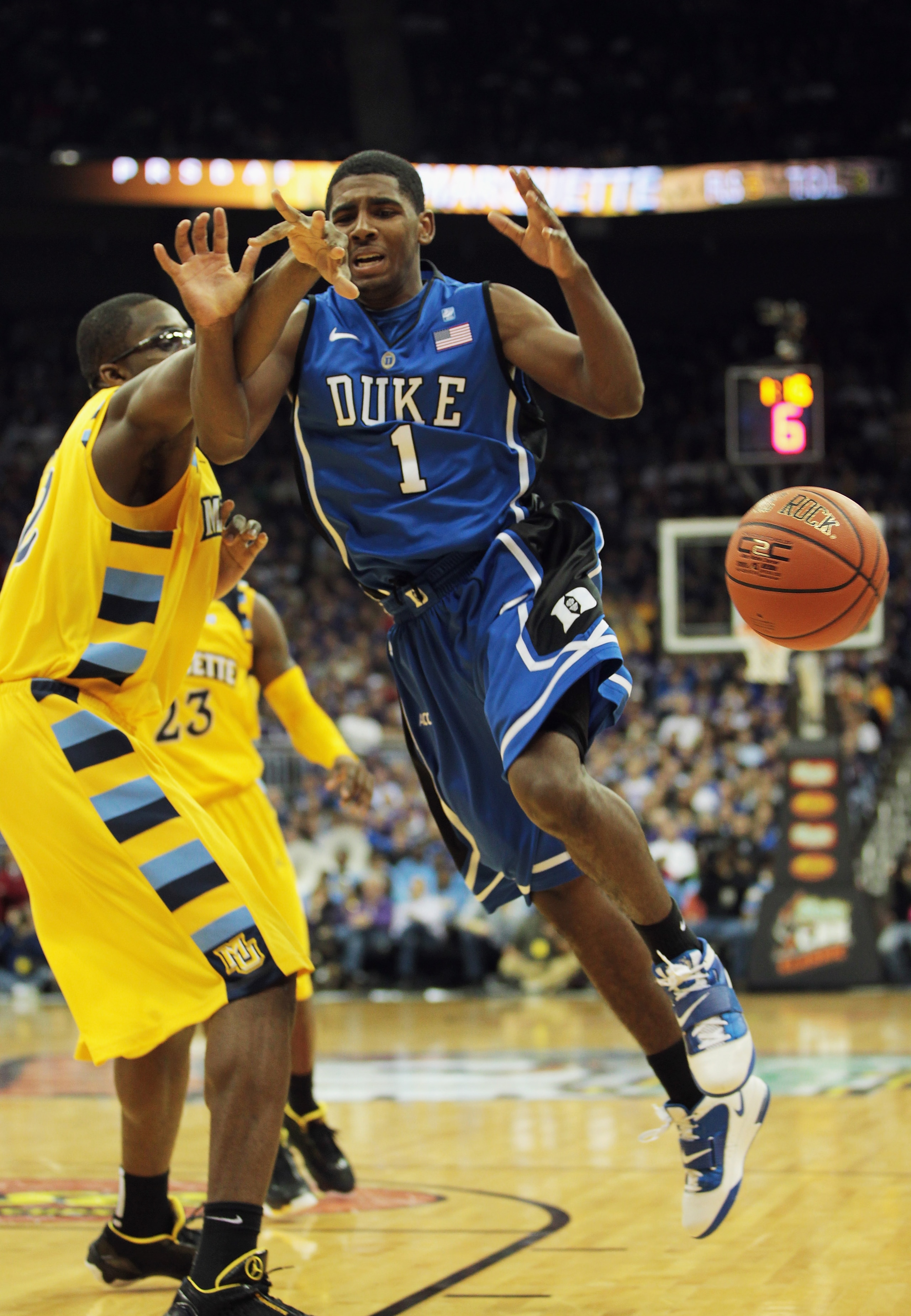 KANSAS CITY, MO - NOVEMBER 22:  Kyrie Irving #1 of the Duke Blue Devils is fouled by Chris Otule #42 of the Marquette Golden Eagles during the CBE Classic game on November 22, 2010 at the Sprint Center in Kansas City, Missouri.  (Photo by Jamie Squire/Get