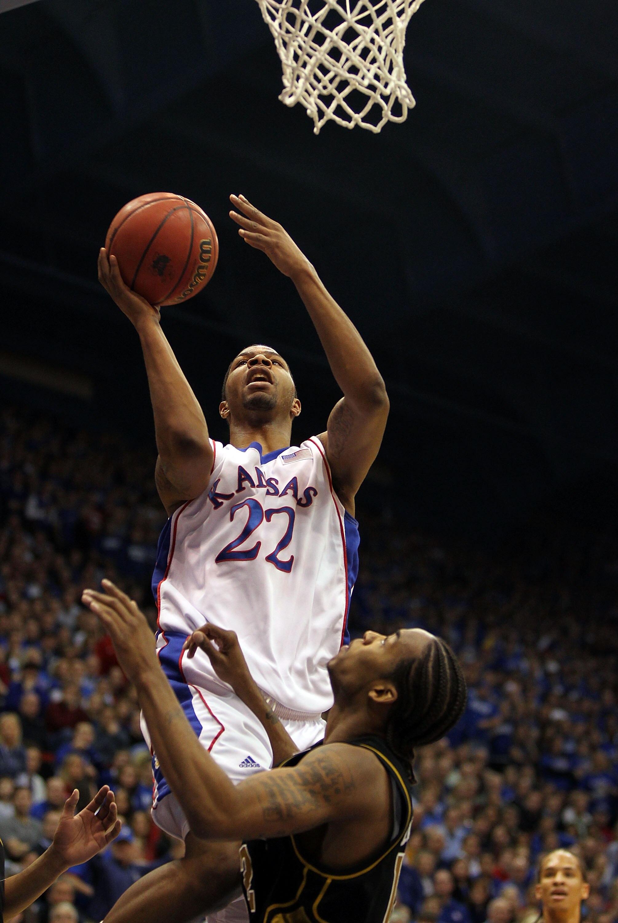 LAWRENCE, KS - JANUARY 25:  Marcus Morris #22 of the Kansas Jayhawks shoots over Marcus Denmon #12 of the Missouri Tigers during the game on January 25, 2010 at Allen Fieldhouse in Lawrence, Kansas.  (Photo by Jamie Squire/Getty Images)