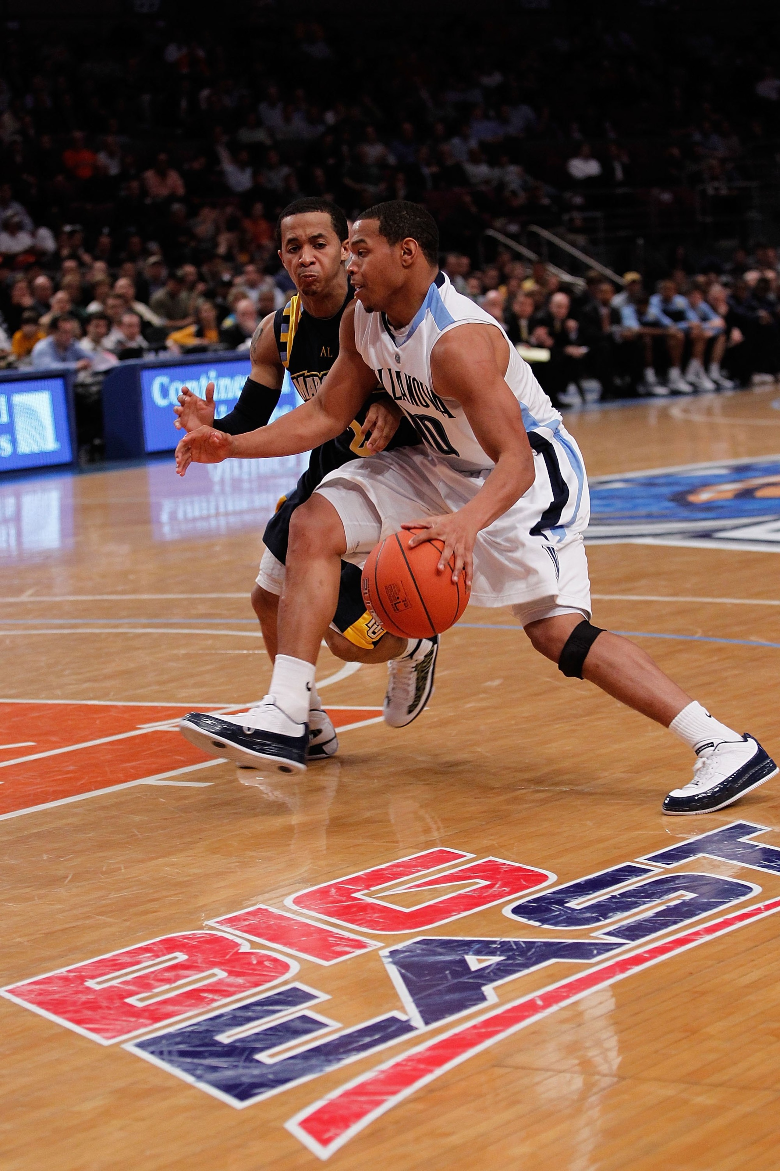 NEW YORK - MARCH 11:  Corey Fisher #10 of the Villanova Wildcats handles the ball against Maurice Acker #2 of the Marquette Golden Eagles during the quarterfinal of the 2010 NCAA Big East Tournament at Madison Square Garden on March 11, 2010 in New York C