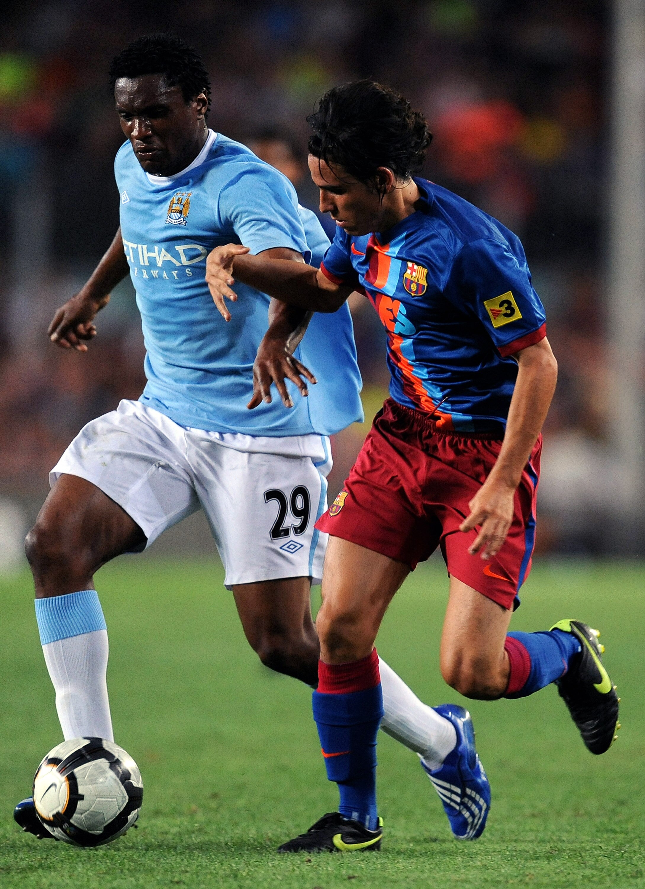 BARCELONA, SPAIN - AUGUST 19:  Gai (R) of Barcelona duels for the ball with Kelvin Etuhu of Manchester City during the Joan Gamper Trophy match between Barcelona and Manchester City at the Camp Nou Stadium on August 19, 2009 in Barcelona, Spain. Mancheste