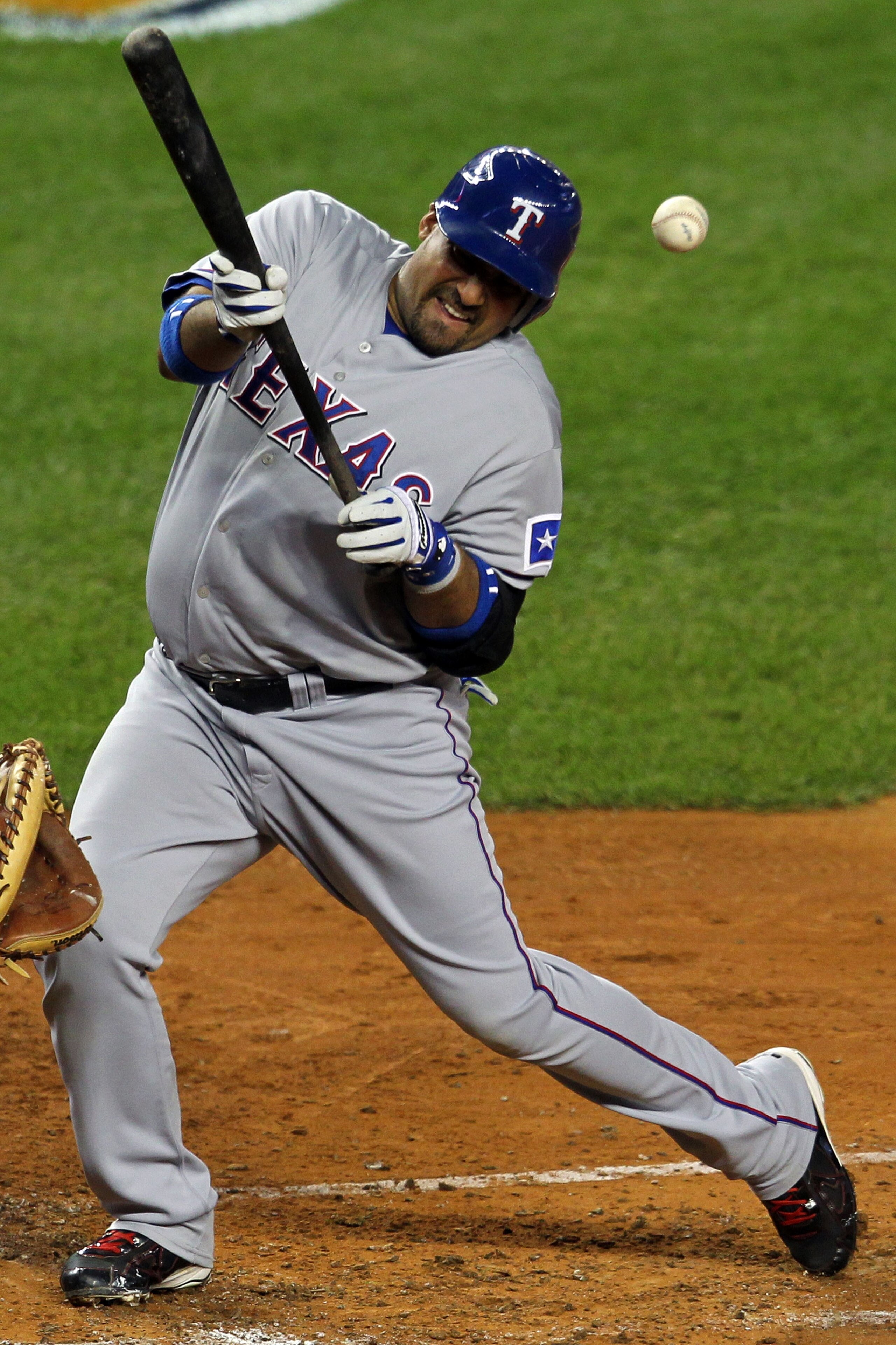 NEW YORK - OCTOBER 19:  Bengie Molina #11 of the Texas Rangers gets hit by a pitch against the New York Yankees in Game Four of the ALCS during the 2010 MLB Playoffs at Yankee Stadium on October 19, 2010 in the Bronx borough of New York City.  (Photo by N