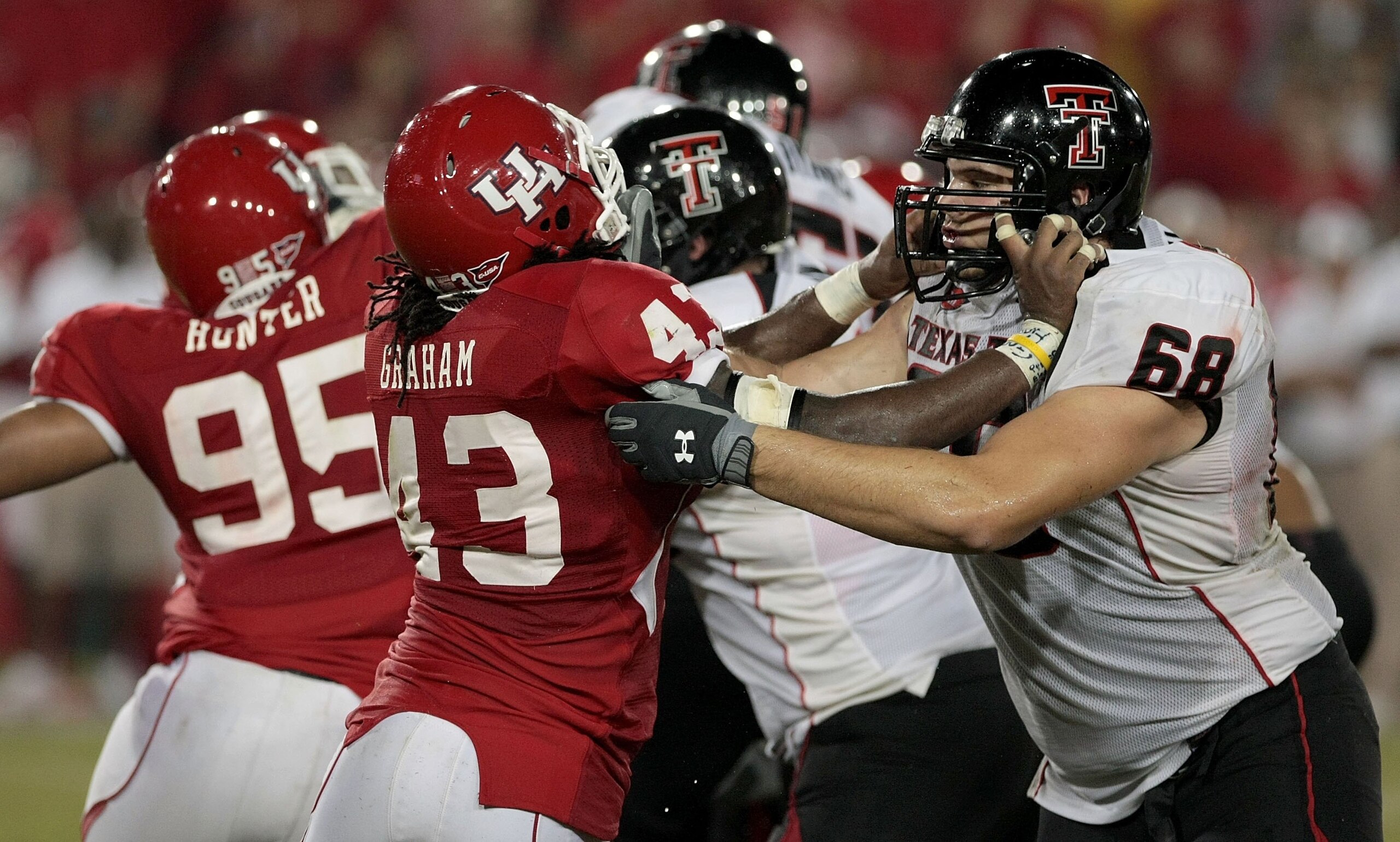 HOUSTON - SEPTEMBER 26: Defensive end Tyrell Graham #43 of the Houston Cougars blocks lineman Terry McDaniel #68 of the Texas Tech Red Raiders at Robertson Stadium on September 26, 2009 in Houston, Texas.  (Photo by Thomas B. Shea/Getty Images)