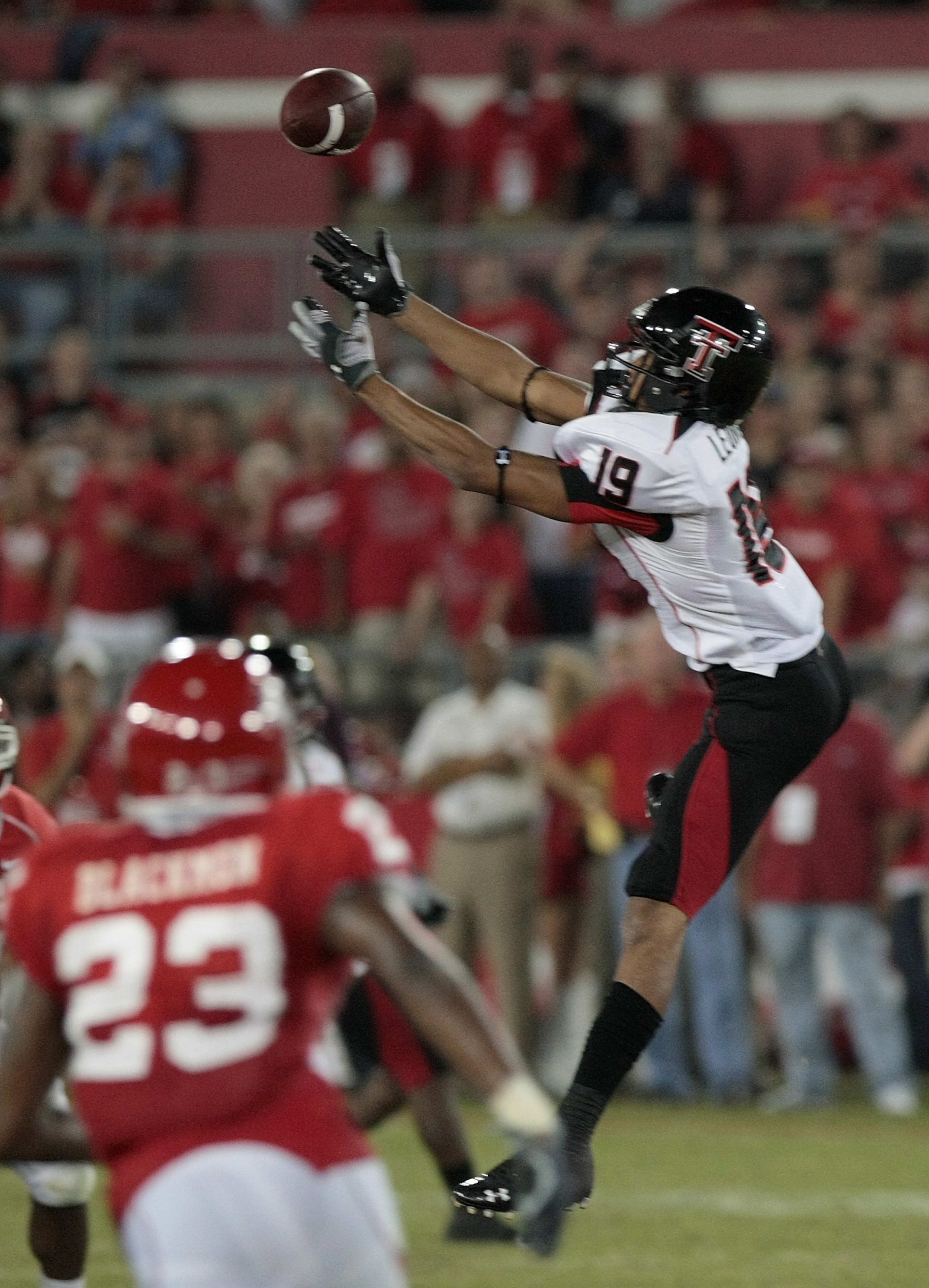 HOUSTON - SEPTEMBER 26: Wide receiver Lyle Leong #19 of the Texas Tech Red Raiders drops a pass against the Houston Cougars at Robertson Stadium on September 26, 2009 in Houston, Texas.  (Photo by Thomas B. Shea/Getty Images)