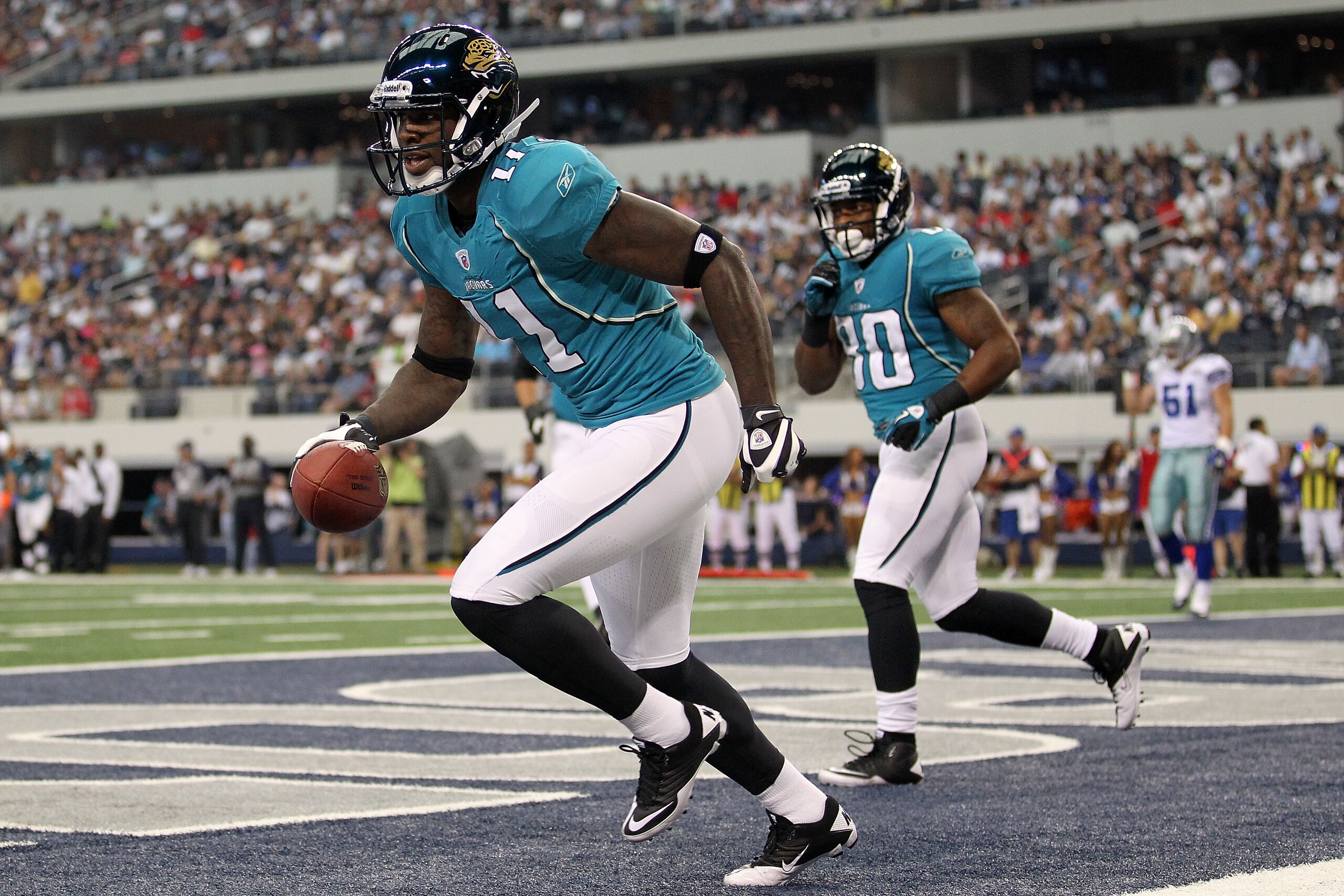 ARLINGTON, TX - OCTOBER 31:  Wide receiver Mike Sims-Walker #11 of the Jacksonville Jaguars celebrates a touchdown against the Dallas Cowboys in the first quarter at Cowboys Stadium on October 31, 2010 in Arlington, Texas.  (Photo by Ronald Martinez/Getty