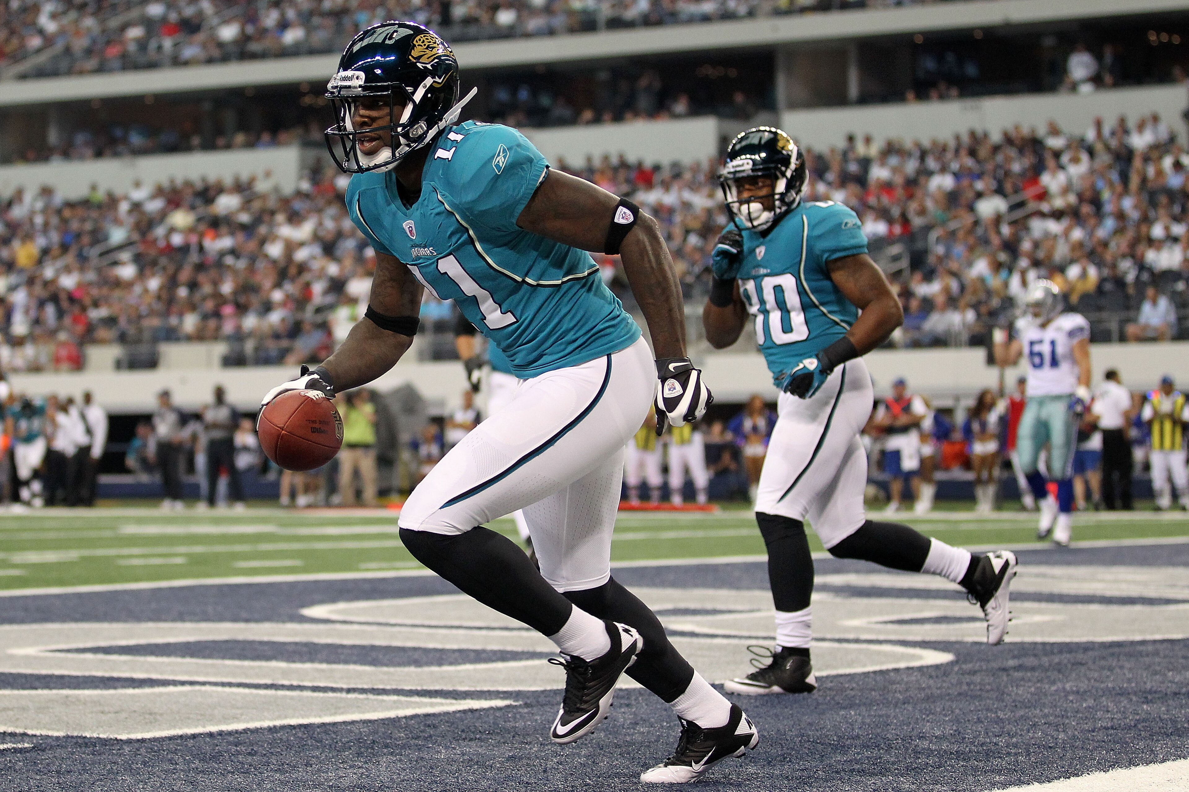 ARLINGTON, TX - OCTOBER 31: Wide receiver Mike Sims-Walker #11 of the Jacksonville Jaguars celebrates a touchdown against the Dallas Cowboys in the first quarter at Cowboys Stadium on October 31, 2010 in Arlington, Texas. (Photo by Ronald Martinez/Getty ARLINGTON, TX - OCTOBER 31: Wide receiver Mike Sims-Walker #11 of the Jacksonville Jaguars celebrates a touchdown against the Dallas Cowboys in the first quarter at Cowboys Stadium on October 31, 2010 in Arlington, Texas. (Photo by Ronald Martinez/Getty