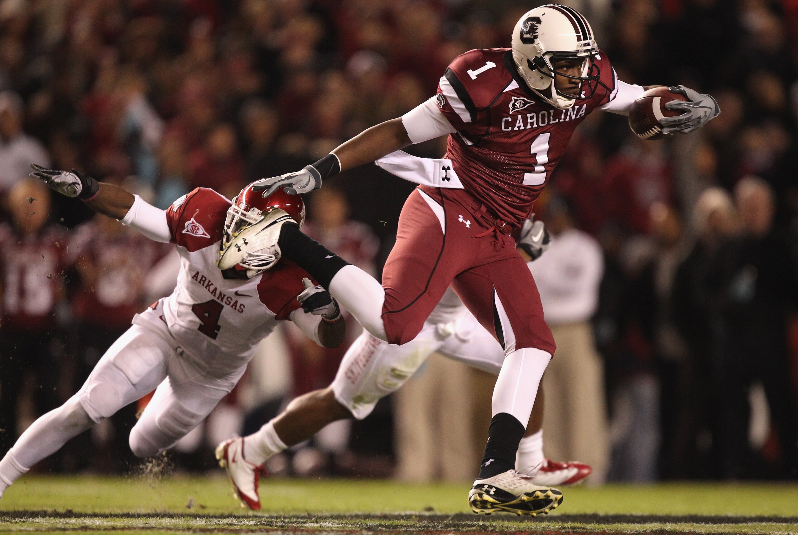 COLUMBIA, SC - NOVEMBER 06:  Teammates Rudell Crim #4 and Ramon Brown #26 of the Arkansas Razorbacks try to stop Alshon Jeffery #1 of the South Carolina Gamecocks during their game at Williams-Brice Stadium on November 6, 2010 in Columbia, South Carolina.