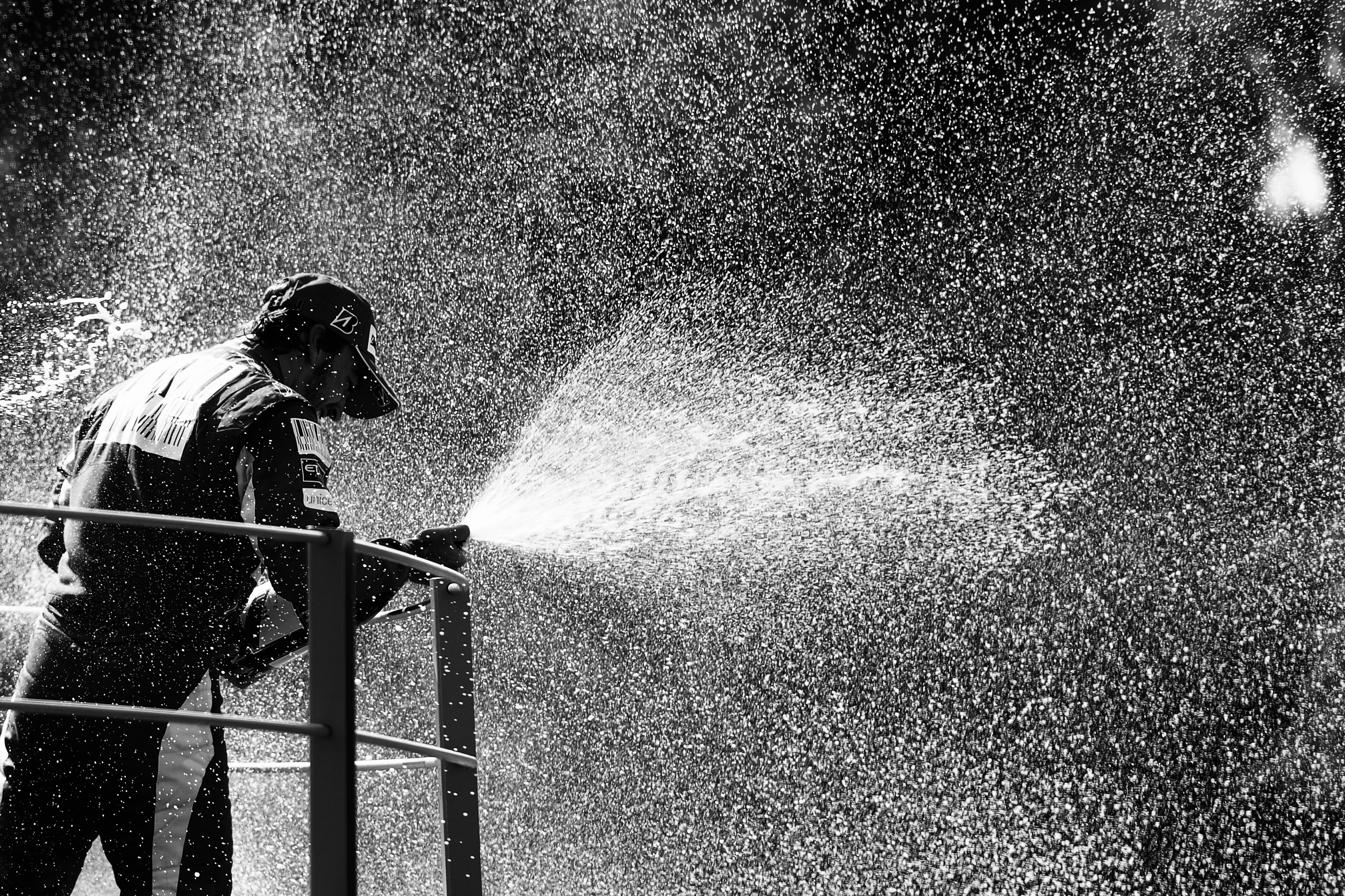 MONZA, ITALY - SEPTEMBER 12:  (EDITORS NOTE: THIS BLACK AND WHITE IMAGE WAS CREATED FROM ORIGINAL COLOUR FILE) Fernando Alonso of Spain and Ferrari celebrates on the podium after winning the Italian Formula One Grand Prix at the Autodromo Nazionale di Mon