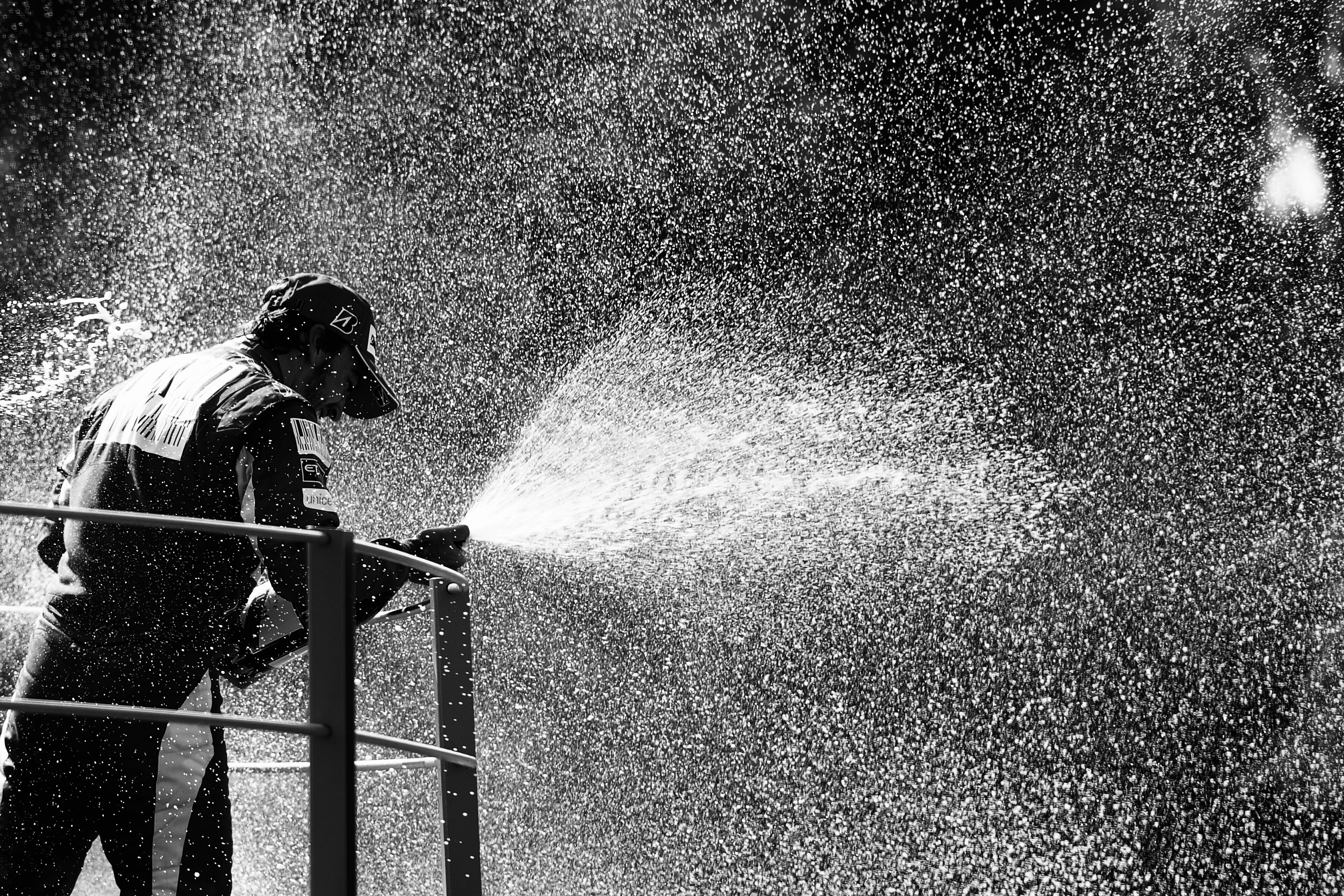 MONZA, ITALY - SEPTEMBER 12:  (EDITORS NOTE: THIS BLACK AND WHITE IMAGE WAS CREATED FROM ORIGINAL COLOUR FILE) Fernando Alonso of Spain and Ferrari celebrates on the podium after winning the Italian Formula One Grand Prix at the Autodromo Nazionale di Mon