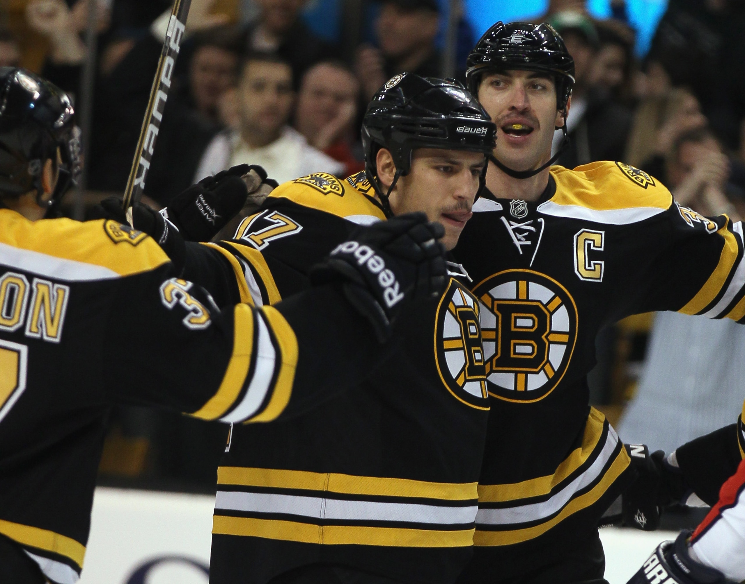 BOSTON - NOVEMBER 18:  Milan Lucic #17 of the Boston Bruins is congratulated by teammates Patrice Bergeron #37 and Zdeno Chara #33 after Lucic scored the firsts goal of the game againstthe Florida Panthers on November 18, 2010 at the TD Garden in Boston,