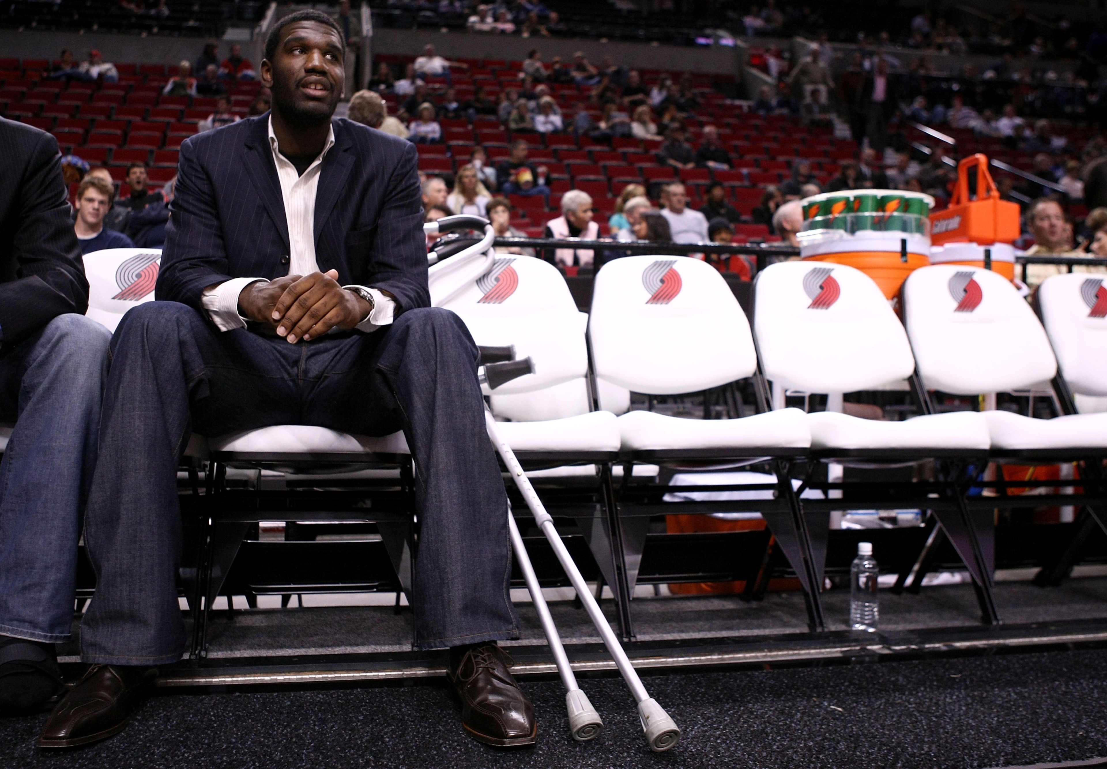 PORTLAND, OR - OCTOBER 10:  Greg Oden #52 of the Portland Trail Blazers, who is out for the season after under going micro fracture surgery in his knee, sits on the bench to watch a pre-season game against the Los Angeles Clippers at the Rose Garden on Oc
