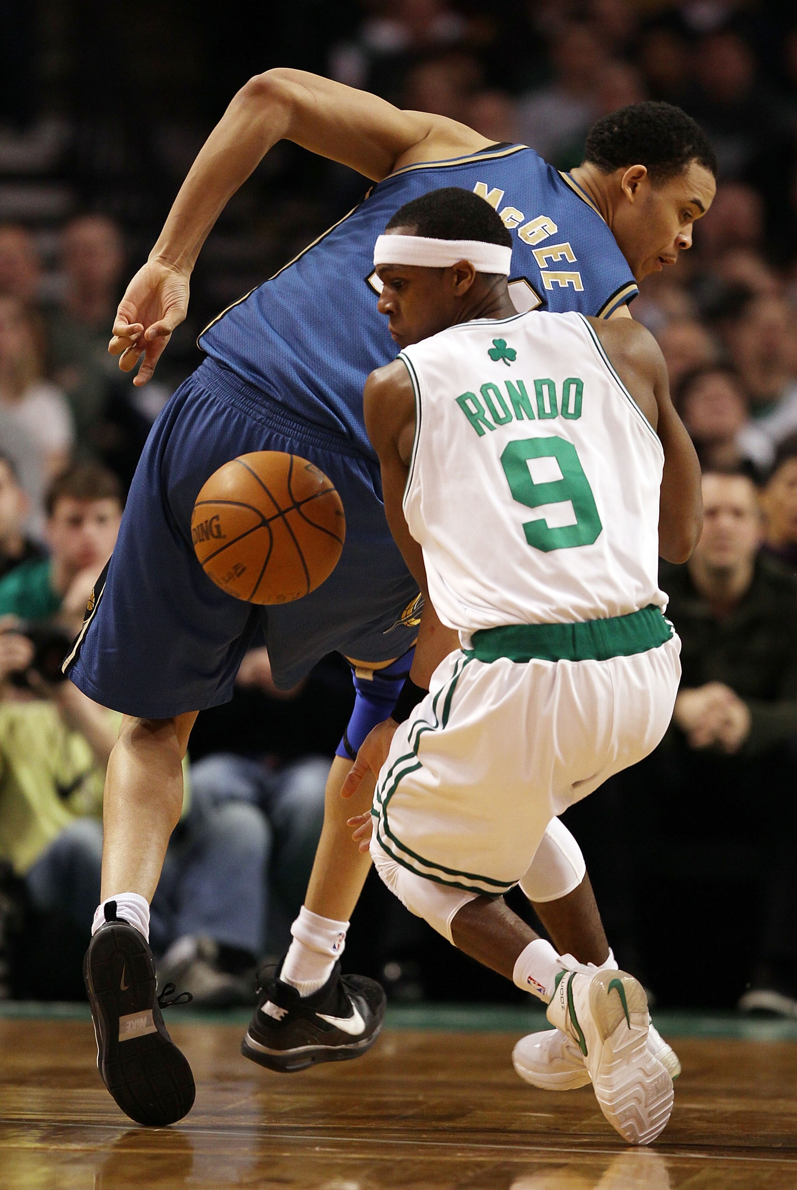 BOSTON - MARCH 07:  Rajon Rondo #9 of the Boston Celtics loses control of the ball as JaVale McGee #34 of the Washington Wizards defends on March 7, 2010 at the TD Garden in Boston, Massachusetts.  NOTE TO USER: User expressly acknowledges and agrees that