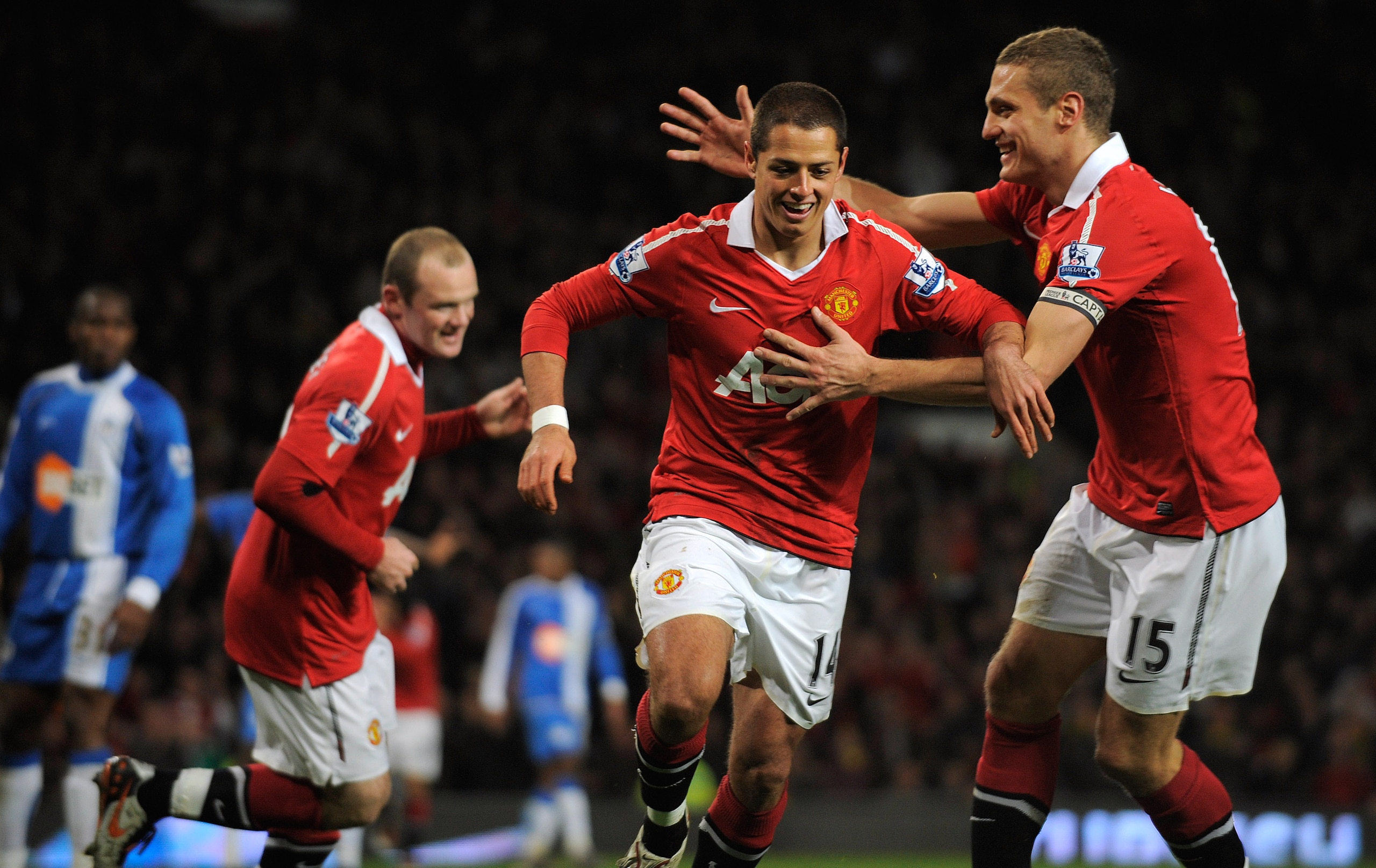 MANCHESTER, ENGLAND - NOVEMBER 20: Javier Hernandez of Manchester United celebrates scoring to make it 2-0 with Nemaja Vidic during the Barclays Premier League match between Manchester United and Wigan Athletic at Old Trafford on November 20, 2010 in Man MANCHESTER, ENGLAND - NOVEMBER 20: Javier Hernandez of Manchester United celebrates scoring to make it 2-0 with Nemaja Vidic during the Barclays Premier League match between Manchester United and Wigan Athletic at Old Trafford on November 20, 2010 in Man