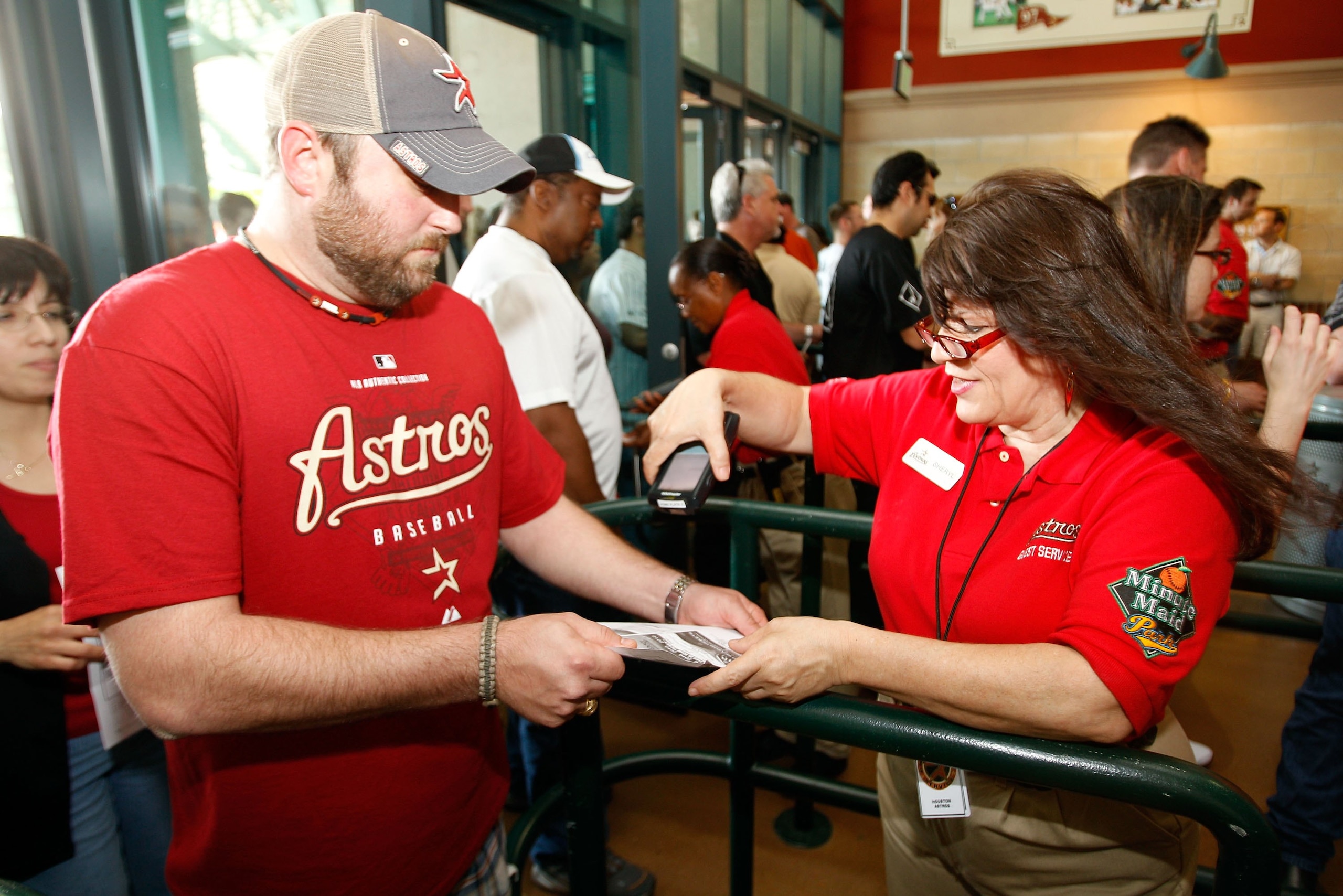 HOUSTON - APRIL 05:  Fans have their tickets scanned on entering the stadium to watch the San Francisco Giants and the Houston Astros on Opening Day at Minute Maid Park on April 5, 2010 in Houston, Texas.  (Photo by Chris Graythen/Getty Images)