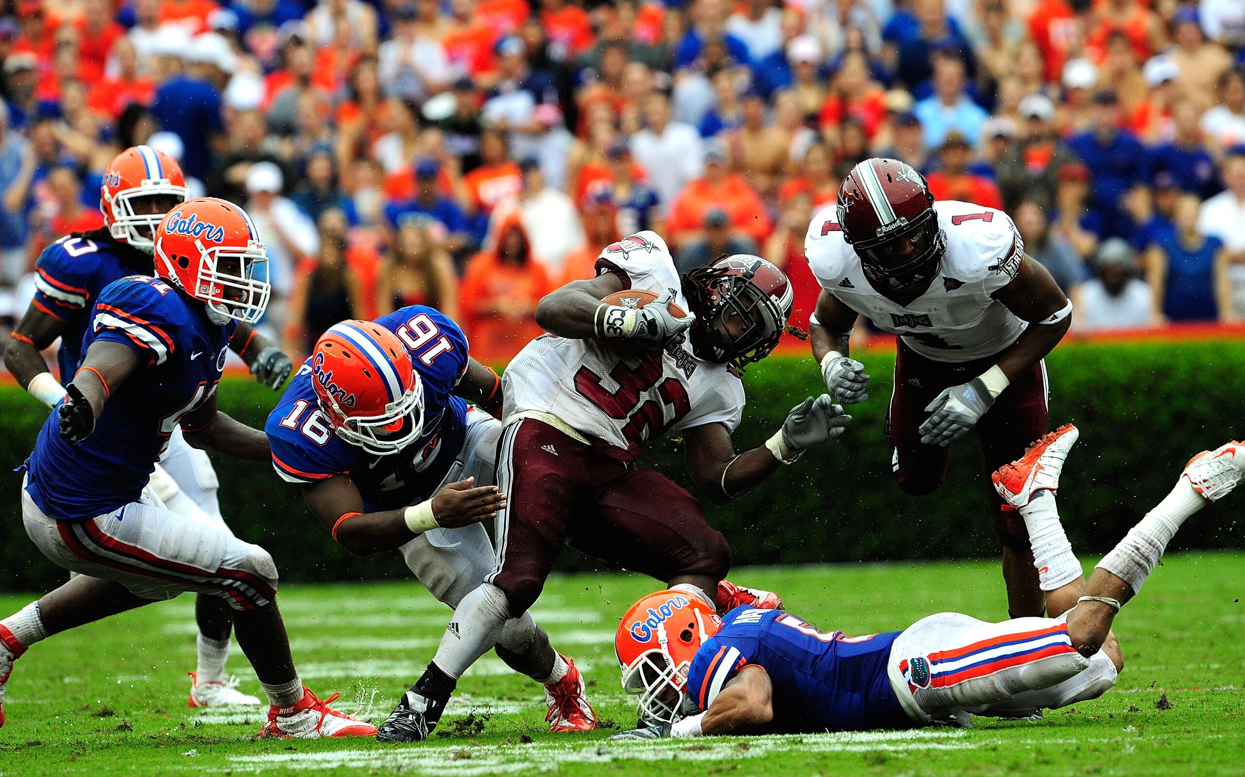 GAINESVILLE, FL - SEPTEMBER 12:  DuJuan Harris #32 of the Troy Trojans is tackled by A.J. Hines #16 of the Florida Gators during the game at Ben Hill Griffin Stadium on September 12, 2009 in Gainesville, Florida.  (Photo by Sam Greenwood/Getty Images)