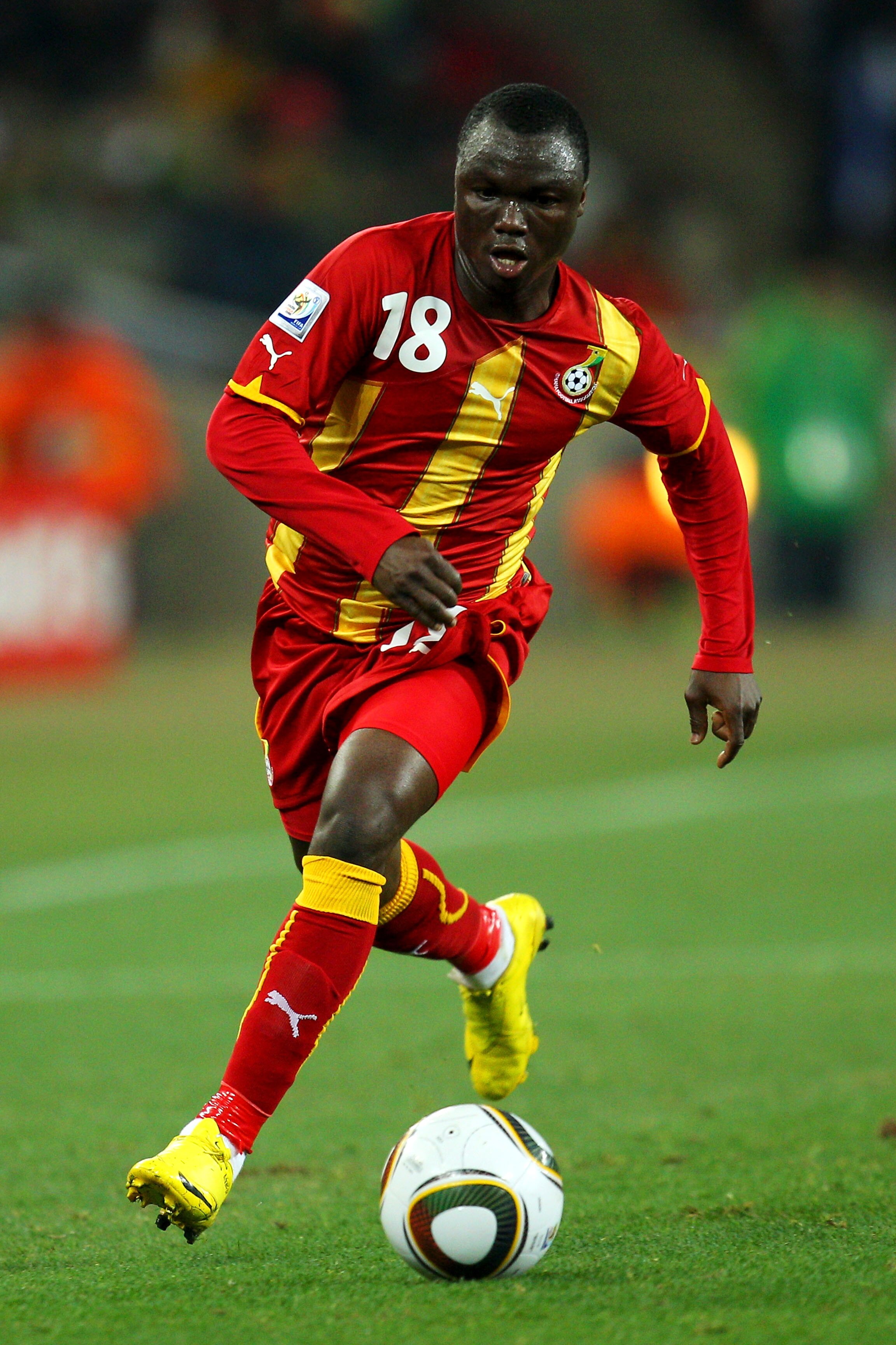 JOHANNESBURG, SOUTH AFRICA - JULY 02:  Dominic Adiyiah of Ghana runs with the ball during the 2010 FIFA World Cup South Africa Quarter Final match between Uruguay and Ghana at the Soccer City stadium on July 2, 2010 in Johannesburg, South Africa.  (Photo