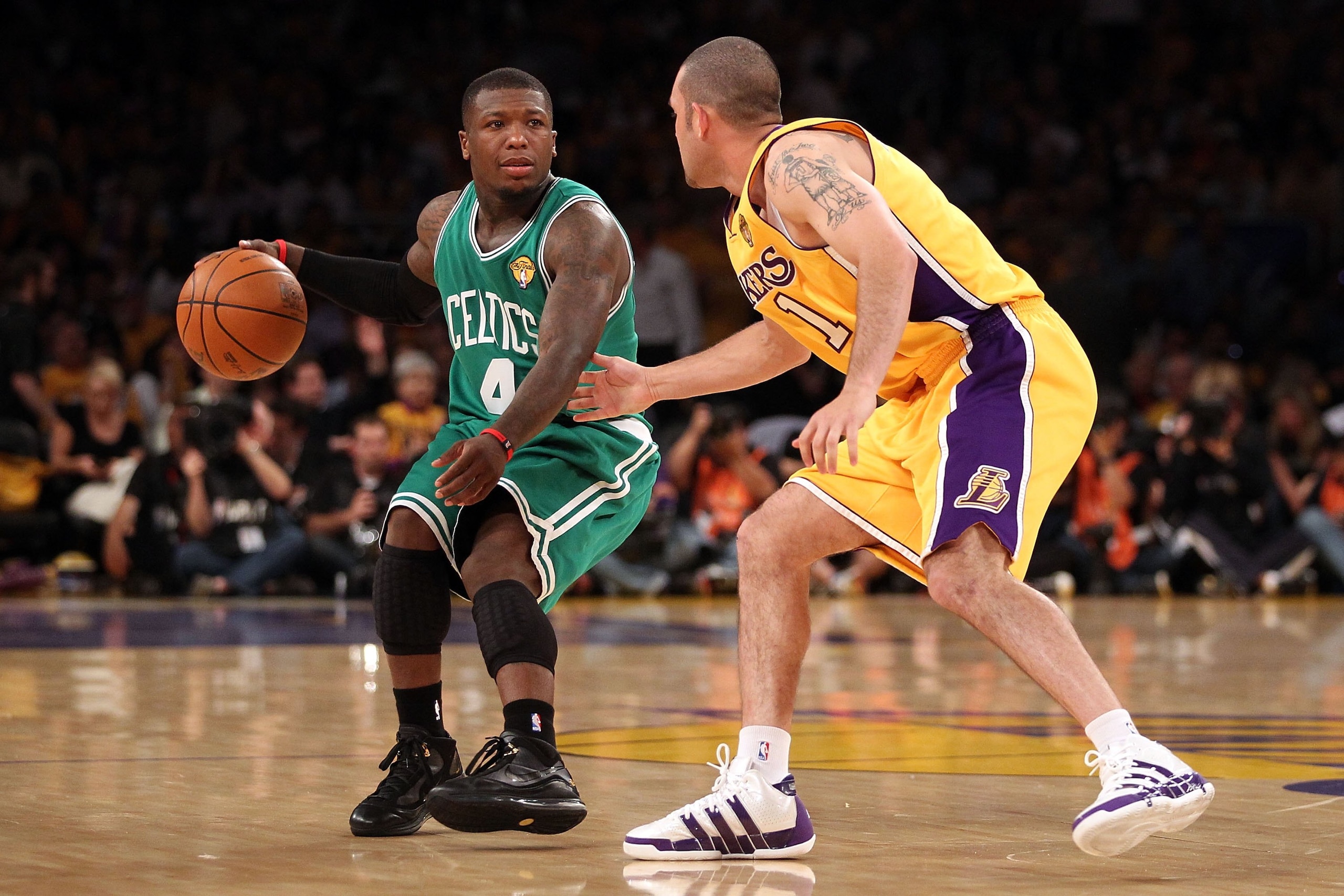 LOS ANGELES, CA - JUNE 15:  Nate Robinson #4 of the Boston Celtics moves the ball against Jordan Farmar #1 of the Los Angeles Lakers in the second half of Game Six of the 2010 NBA Finals at Staples Center on June 15, 2010 in Los Angeles, California.  NOTE