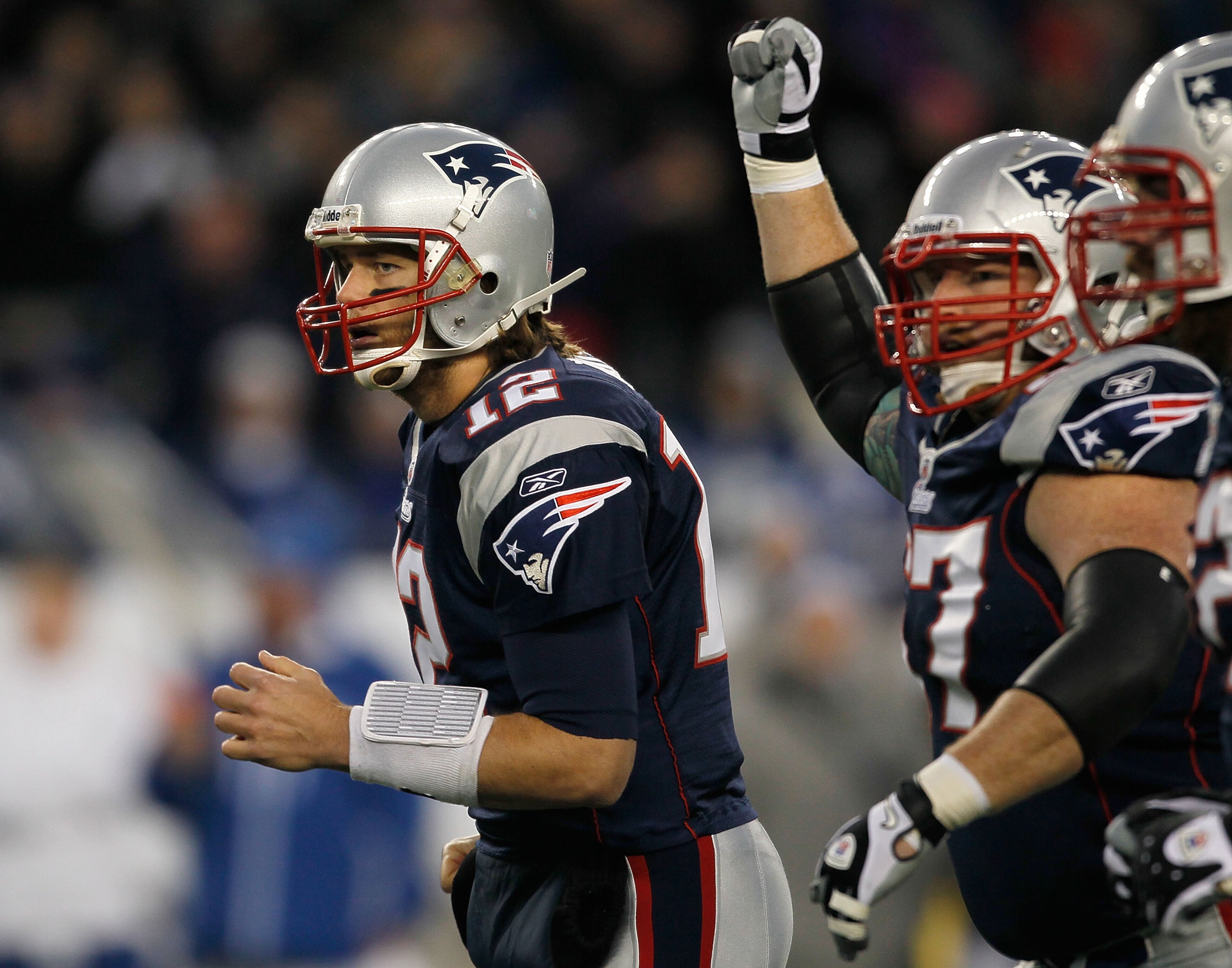 FOXBORO, MA - NOVEMBER 21: Tom Brady #12 of the New England Patriots reacts with teammate Dan Koppen #67 of the New England Patriots after a touchdown in the first half at Gillette Stadium on November 21, 2010 in Foxboro, Massachusetts. (Photo by Jim Roga