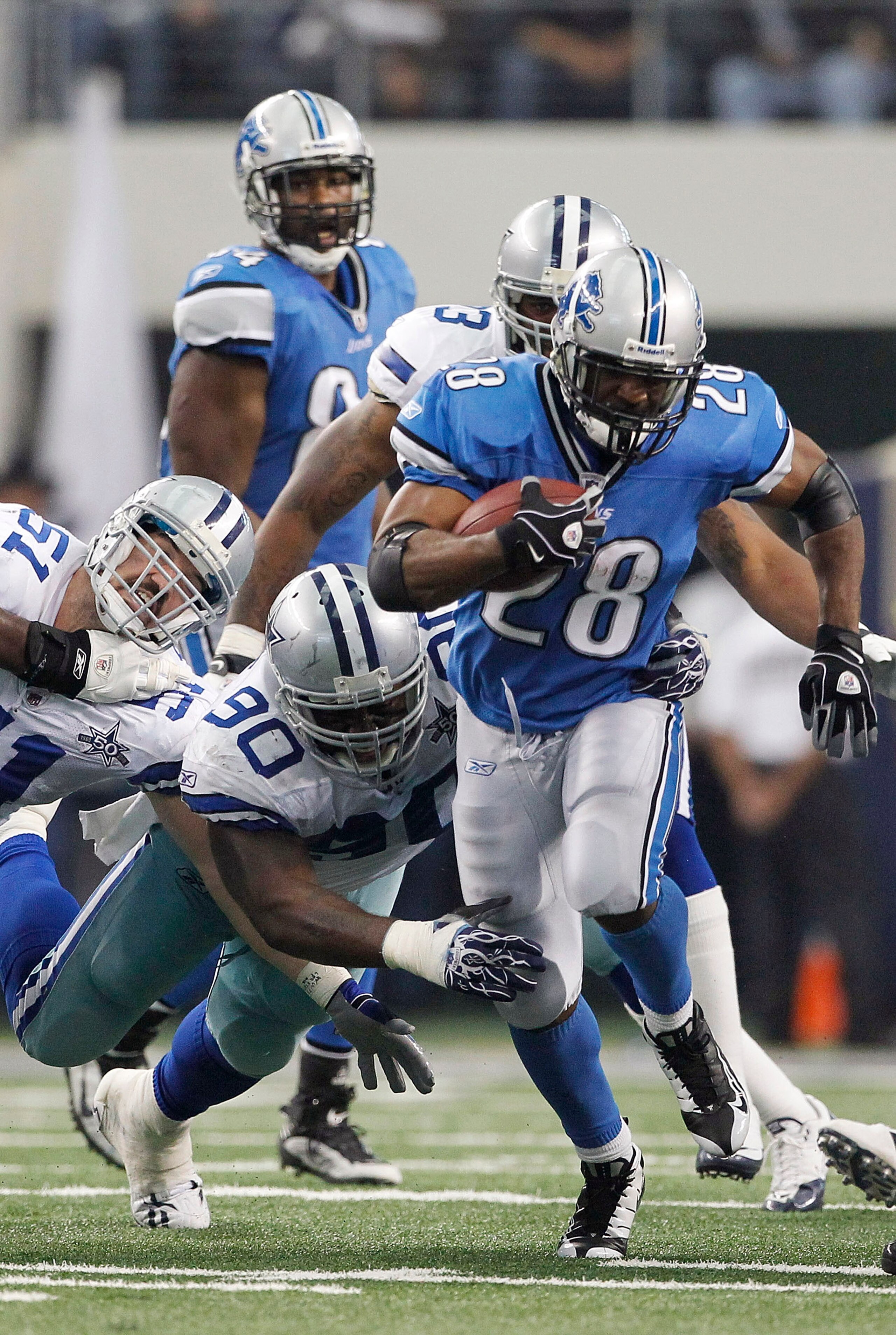ARLINGTON, TX - NOVEMBER 21: Maurice Morris #28 of the Detroit Lions runs for a first down as Jay Ratliff #90 of the Dallas Cowboys attempts to make the stop during the game at Dallas Stadium on November 21, 2010 in Arlington, Texas. The Cowboys defeated