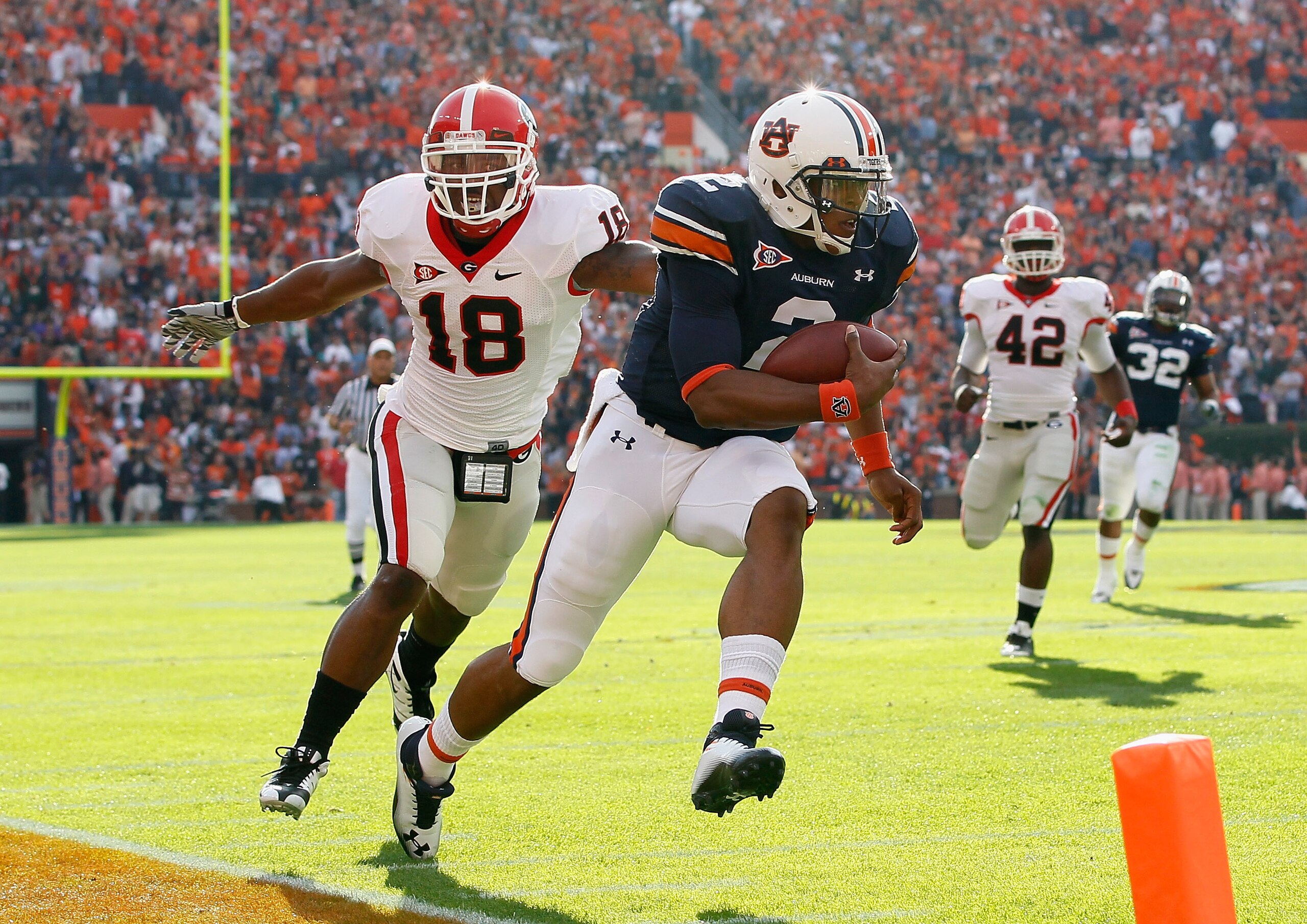 AUBURN, AL - NOVEMBER 13: Quarterback Cameron Newton #2 of the Auburn Tigers rushes for a touchdown past Bacarri Rambo #18 of the Georgia Bulldogs at Jordan-Hare Stadium on November 13, 2010 in Auburn, Alabama. (Photo by Kevin C. Cox/Getty Images) AUBURN, AL - NOVEMBER 13: Quarterback Cameron Newton #2 of the Auburn Tigers rushes for a touchdown past Bacarri Rambo #18 of the Georgia Bulldogs at Jordan-Hare Stadium on November 13, 2010 in Auburn, Alabama. (Photo by Kevin C. Cox/Getty Images)