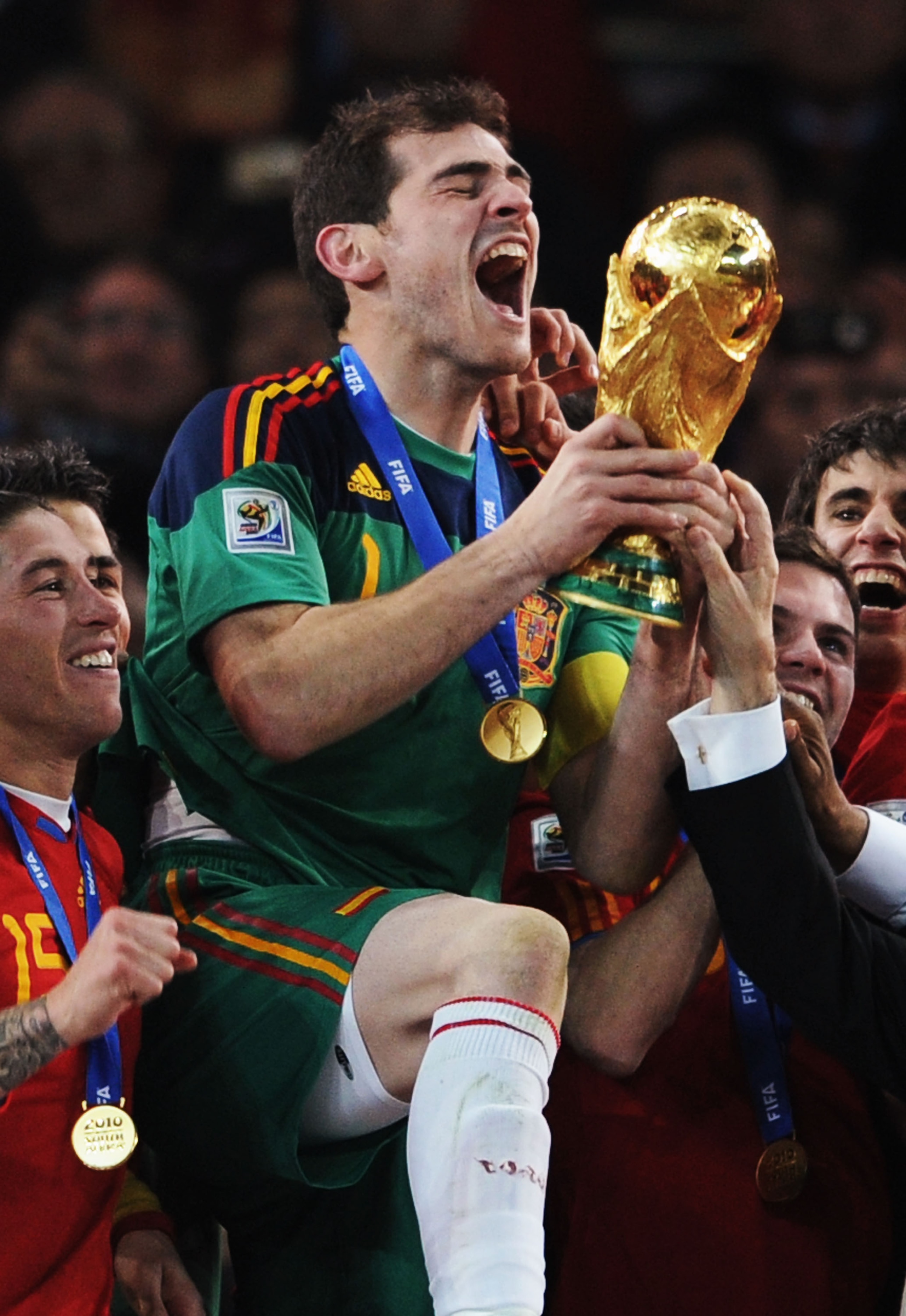 JOHANNESBURG, SOUTH AFRICA - JULY 11:  Iker Casillas, captain of Spain (C), and the Spain team celebrate victory with the World Cup trophy following the 2010 FIFA World Cup South Africa Final match between Netherlands and Spain at Soccer City Stadium on J