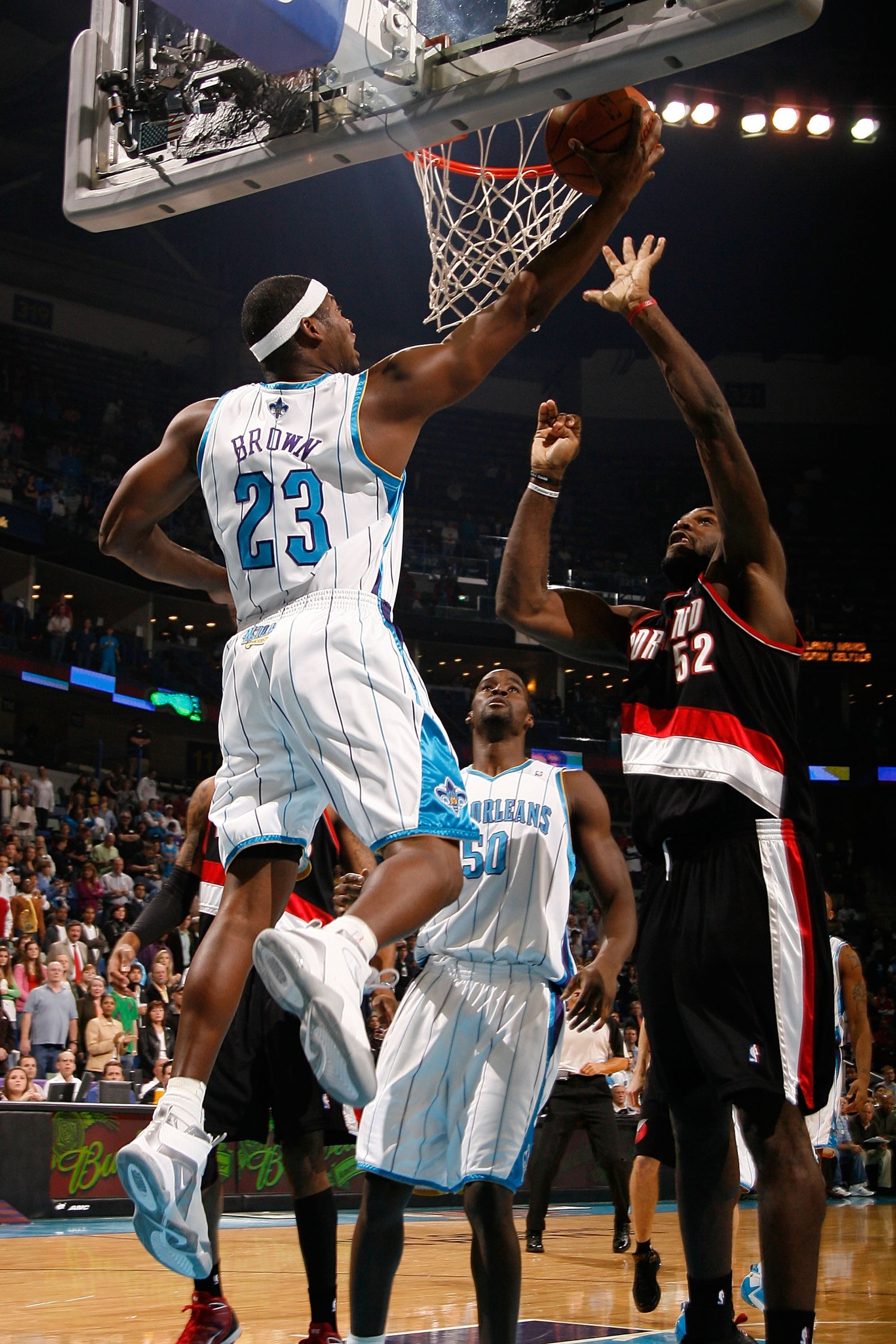 NEW ORLEANS - NOVEMBER 13:  Devin Brown #23 of the New Orleans Hornets shoots the ball over Greg Oden #52 of the Portland Trail Blazers at the New Orleans Arena on November 13, 2009 in New Orleans, Louisiana.  NOTE TO USER: User expressly acknowledges and