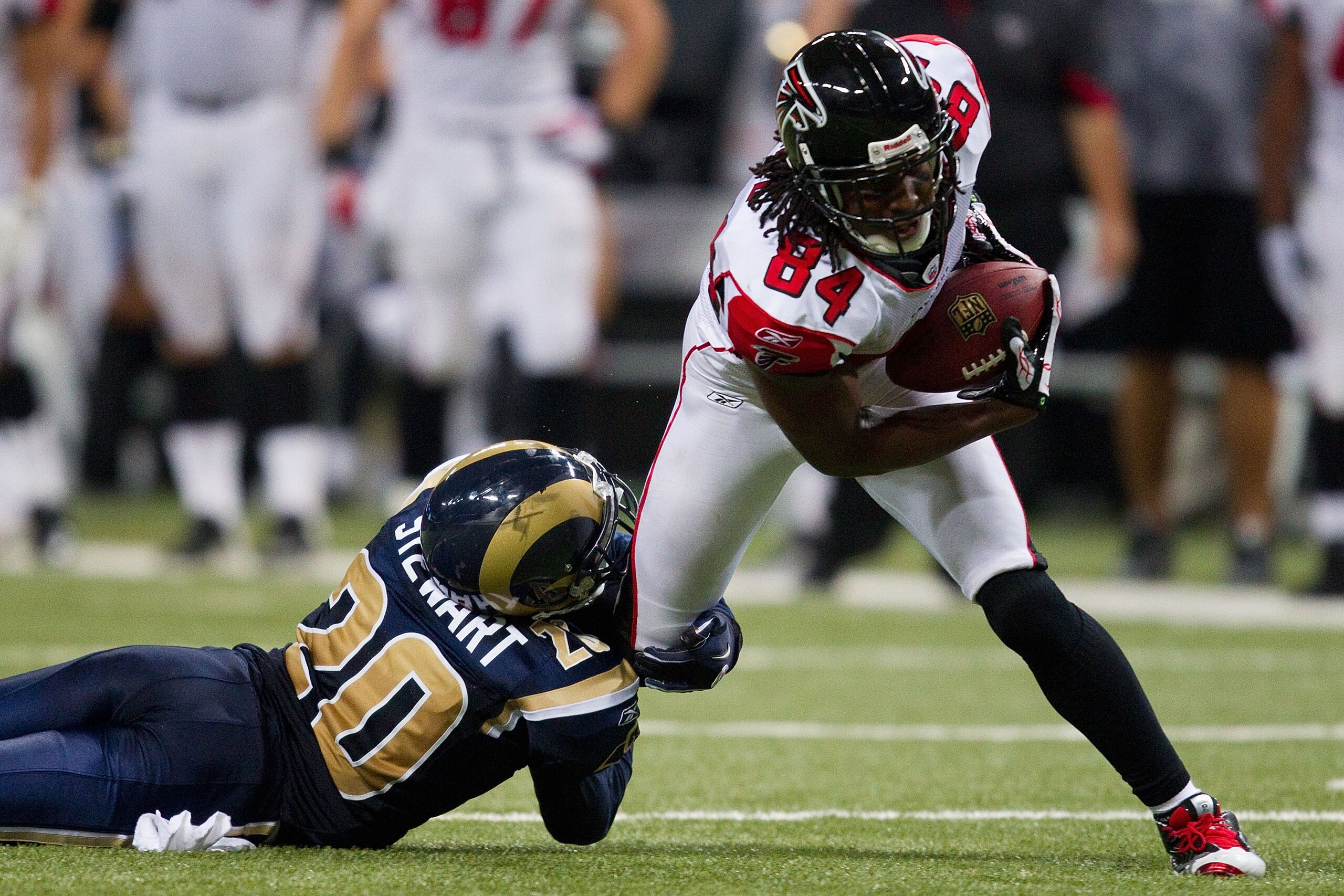 ST. LOUIS - NOVEMBER 21: Roddy White #84 of the Atlanta Falcons looks to slip past Darian Stewart #20 of the St. Louis Rams at the Edward Jones Dome on November 21, 2010 in St. Louis, Missouri.  The Falcons beat the Rams 34-17.  (Photo by Dilip Vishwanat/