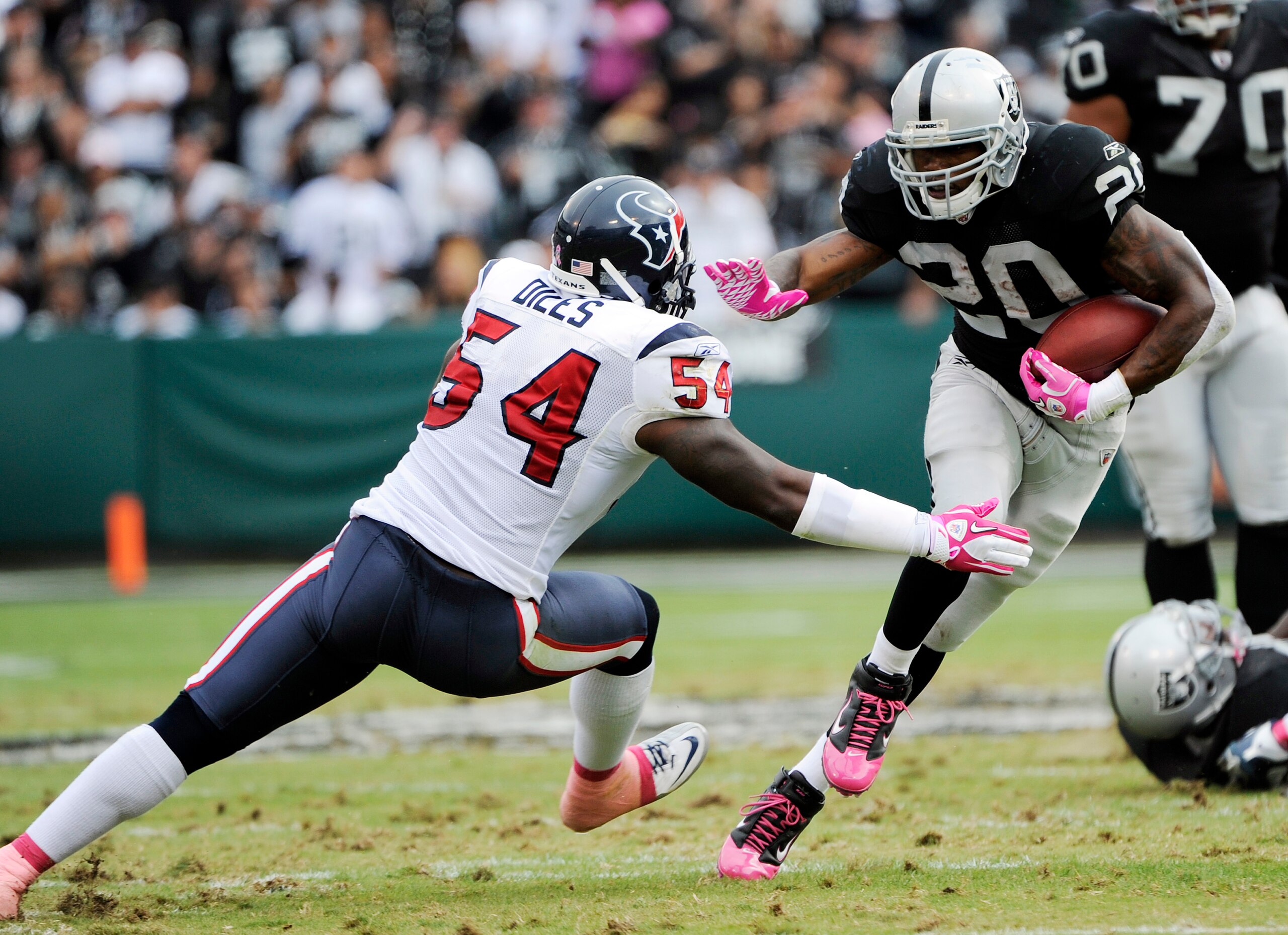 OAKLAND, CA - OCTOBER 3:  Running Back Darren McFadden #20 of the Oakland Raider tries to avoid the tackle of linebacker Zac Diles #54 of the Houston Texans during an NFL football game October 3, 2010 at The Oakland-Alameda County Coliseum in Oakland, Cal