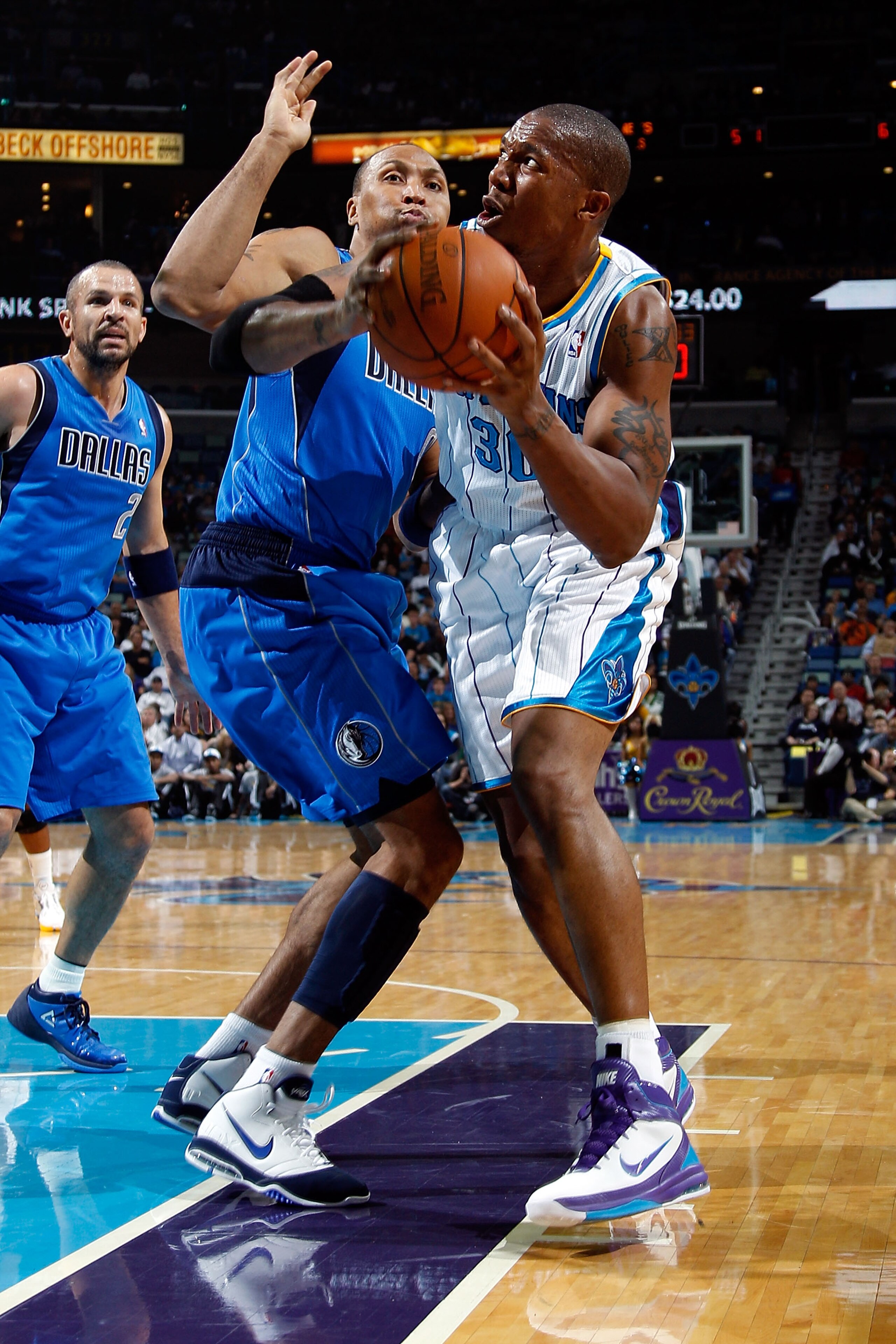 NEW ORLEANS - NOVEMBER 17:  David West #30 of the New Orleans Hornets looks to shoot over Shawn Maroin #0 of the Dallas Mavericks at the New Orleans Arena on November 17, 2010 in New Orleans, Louisiana.  NOTE TO USER: User expressly acknowledges and agree