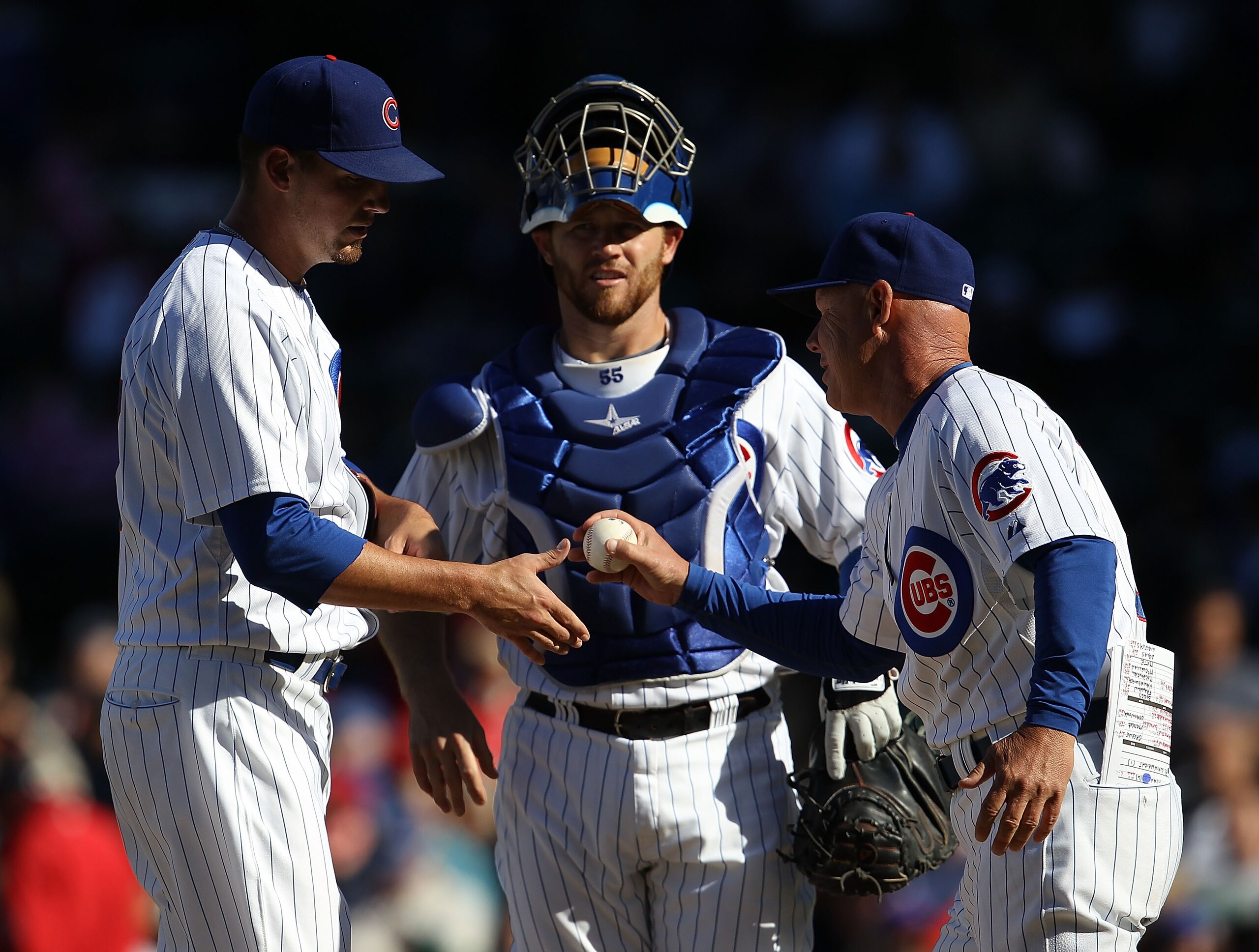 CHICAGO - SEPTEMBER 24: Interim manager Mike Quade #8 of the Chicago Cubs takes pitcher Scott Maine #57 out of a game against the St. Louis Cardinals as Koyie Hill #55 watches at Wrigley Field on September 24, 2010 in Chicago, Illinois. The CArdinals defe