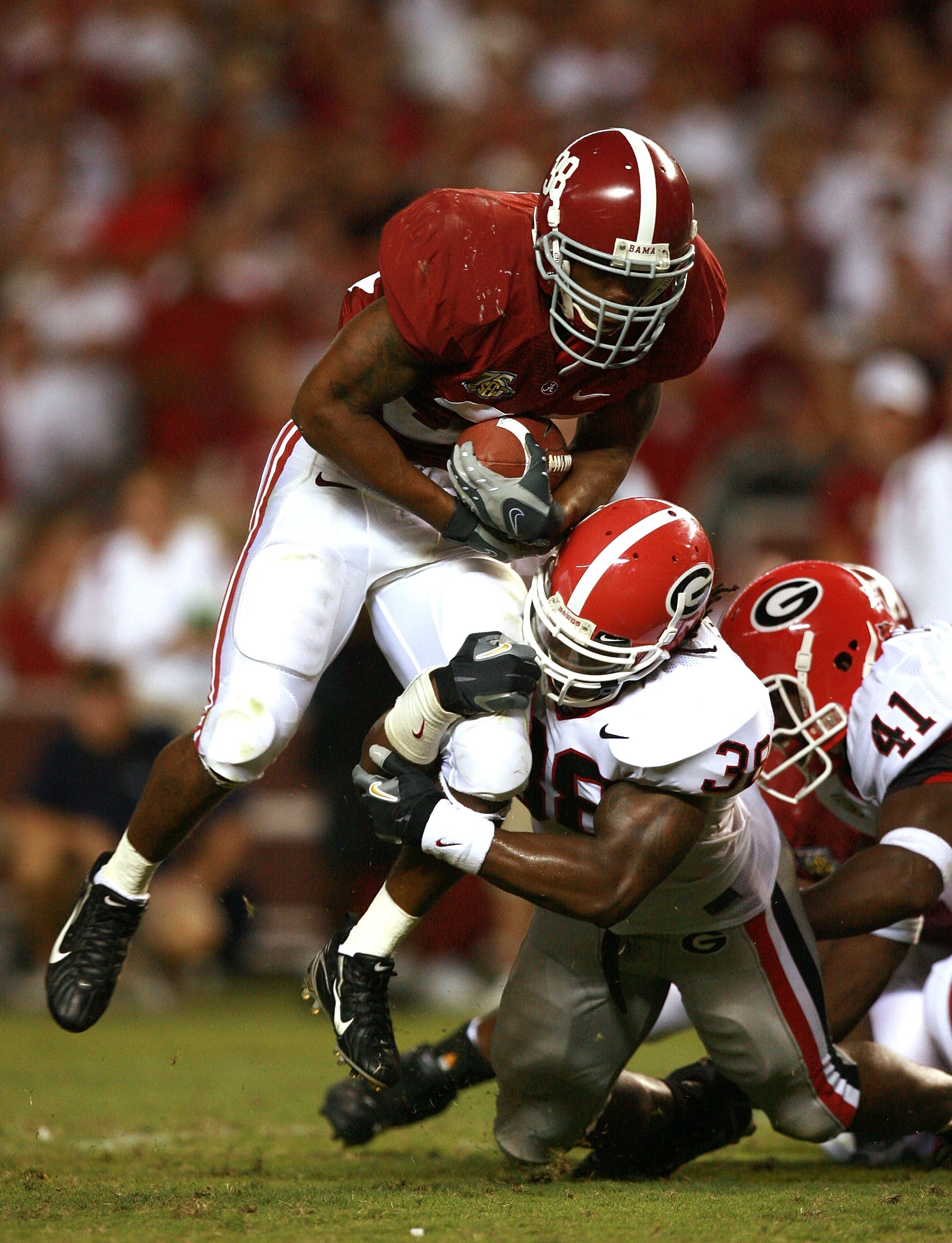 TUSCALOOSA, AL - SEPTEMBER 22:  Defensive end Marcus Howard #38 of the Georgia Bulldogs brings down running back Glen Coffee #38 of the Alabama Crimson Tide at Bryant-Denny Stadium September 22, 2007 in Tuscaloosa, Alabama. Georgia defeated Alabama 26-23