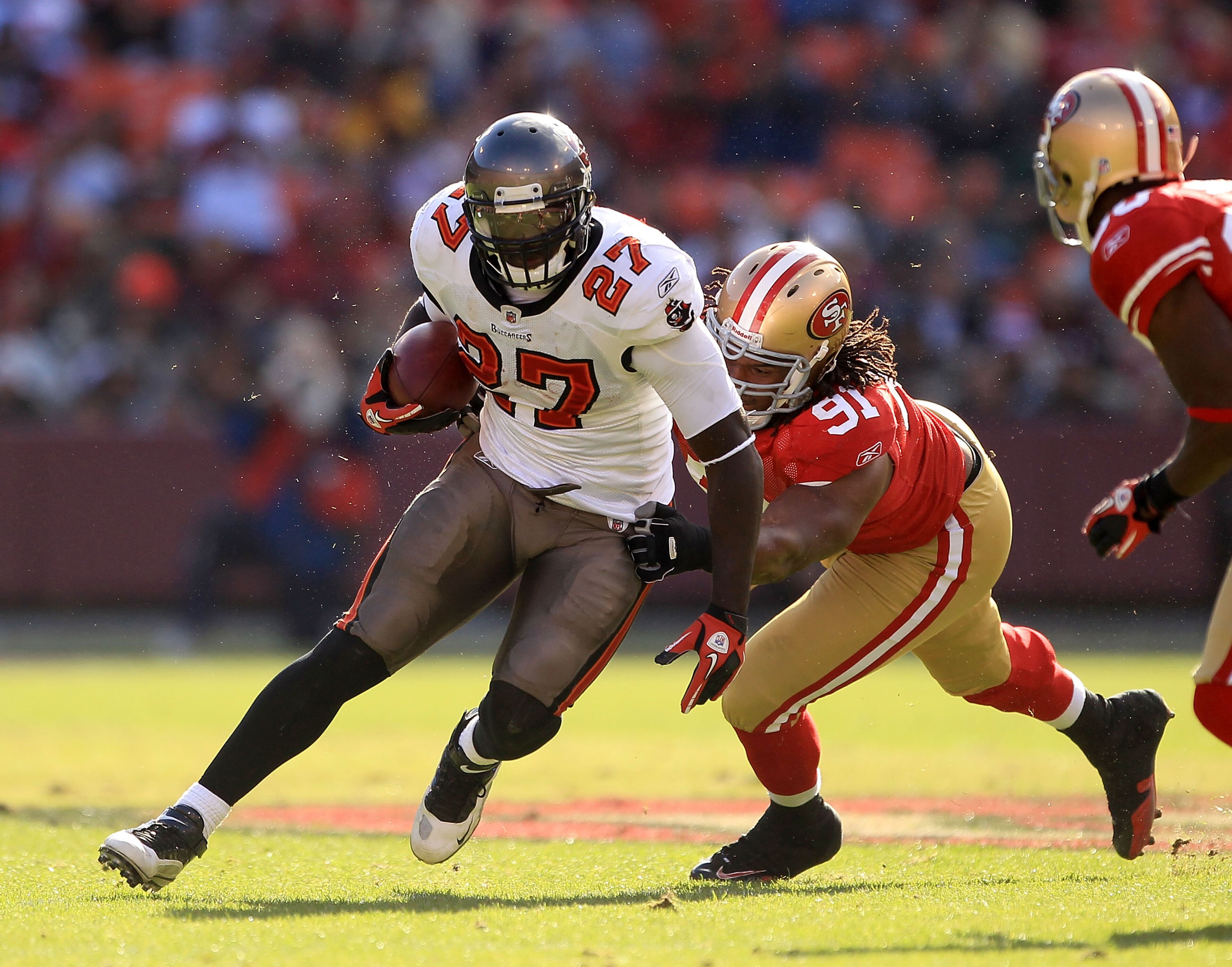 SAN FRANCISCO - NOVEMBER 21:  LeGarrette Blount #27 of the Tampa Bay Buccaneers is tackled by the Ray McDonald #91 of the San Francisco 49ers at Candlestick Park on November 21, 2010 in San Francisco, California.  (Photo by Ezra Shaw/Getty Images)