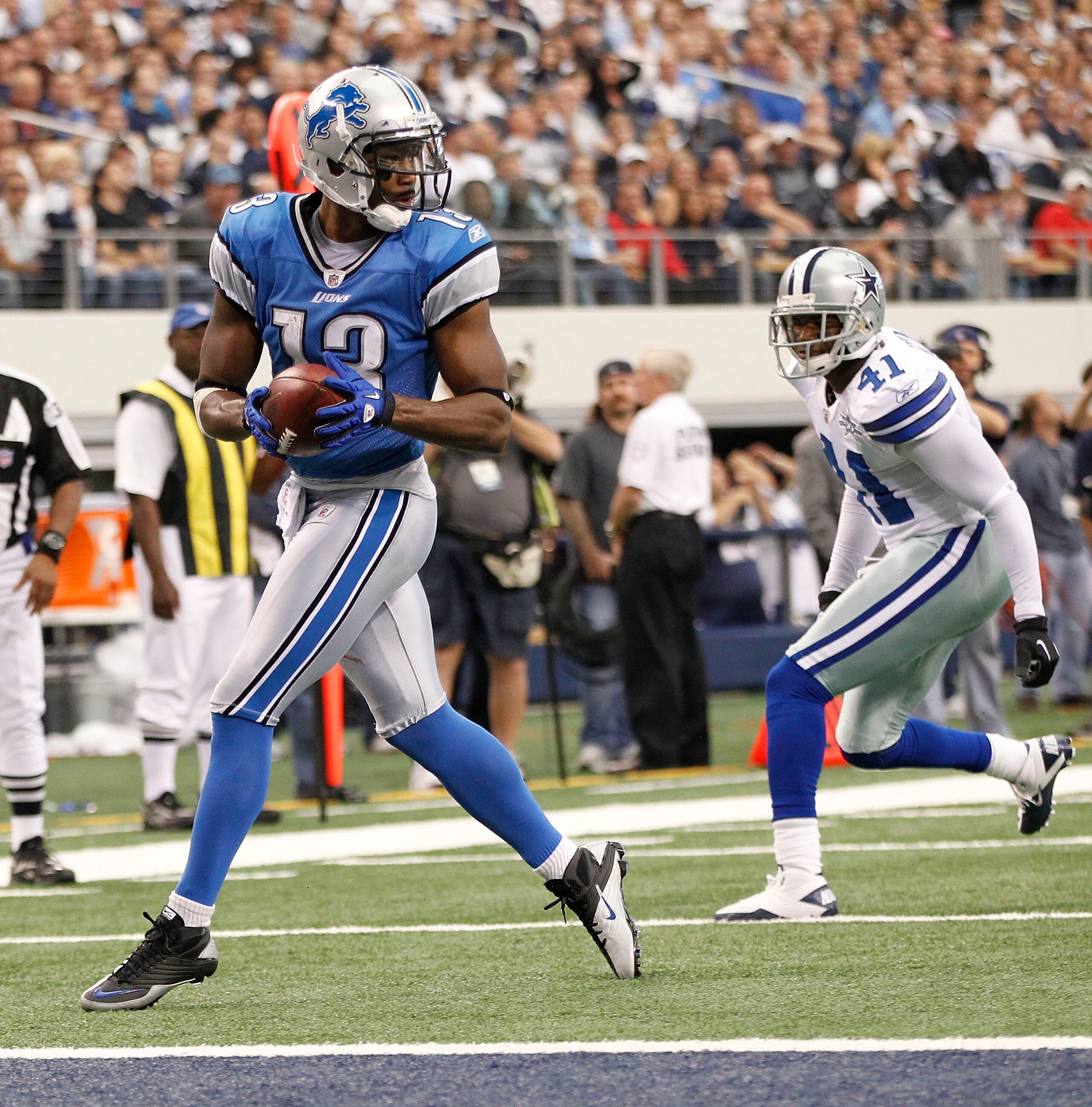 ARLINGTON, TX - NOVEMBER 21: Nate Burleson #13 of the Detroit Lions scores a late second quarter touchdown as Terence Newman #41 of the Dallas Cowboys defends at Dallas Stadium on November 21, 2010 in Arlington, Texas. (Photo by Leon Halip/Getty Images) ARLINGTON, TX - NOVEMBER 21: Nate Burleson #13 of the Detroit Lions scores a late second quarter touchdown as Terence Newman #41 of the Dallas Cowboys defends at Dallas Stadium on November 21, 2010 in Arlington, Texas. (Photo by Leon Halip/Getty Images)