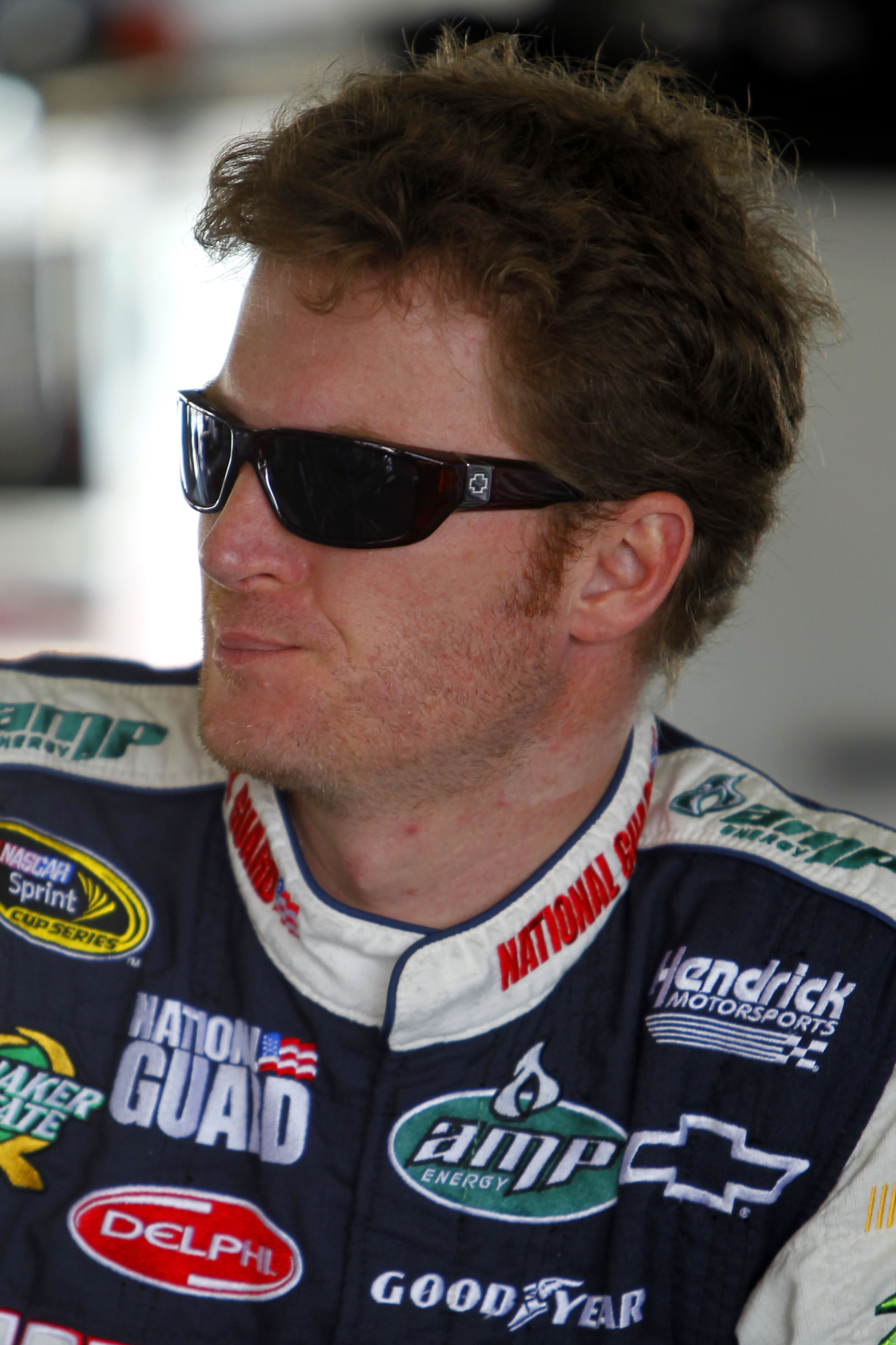 HOMESTEAD, FL - NOVEMBER 20:  Dale Earnhardt Jr., driver of the #88 National Guard/AMP Energy Chevrolet, stands in the garage during practice for the NASCAR Sprint Cup Series Ford 400 at Homestead-Miami Speedway on November 20, 2010 in Homestead, Florida.
