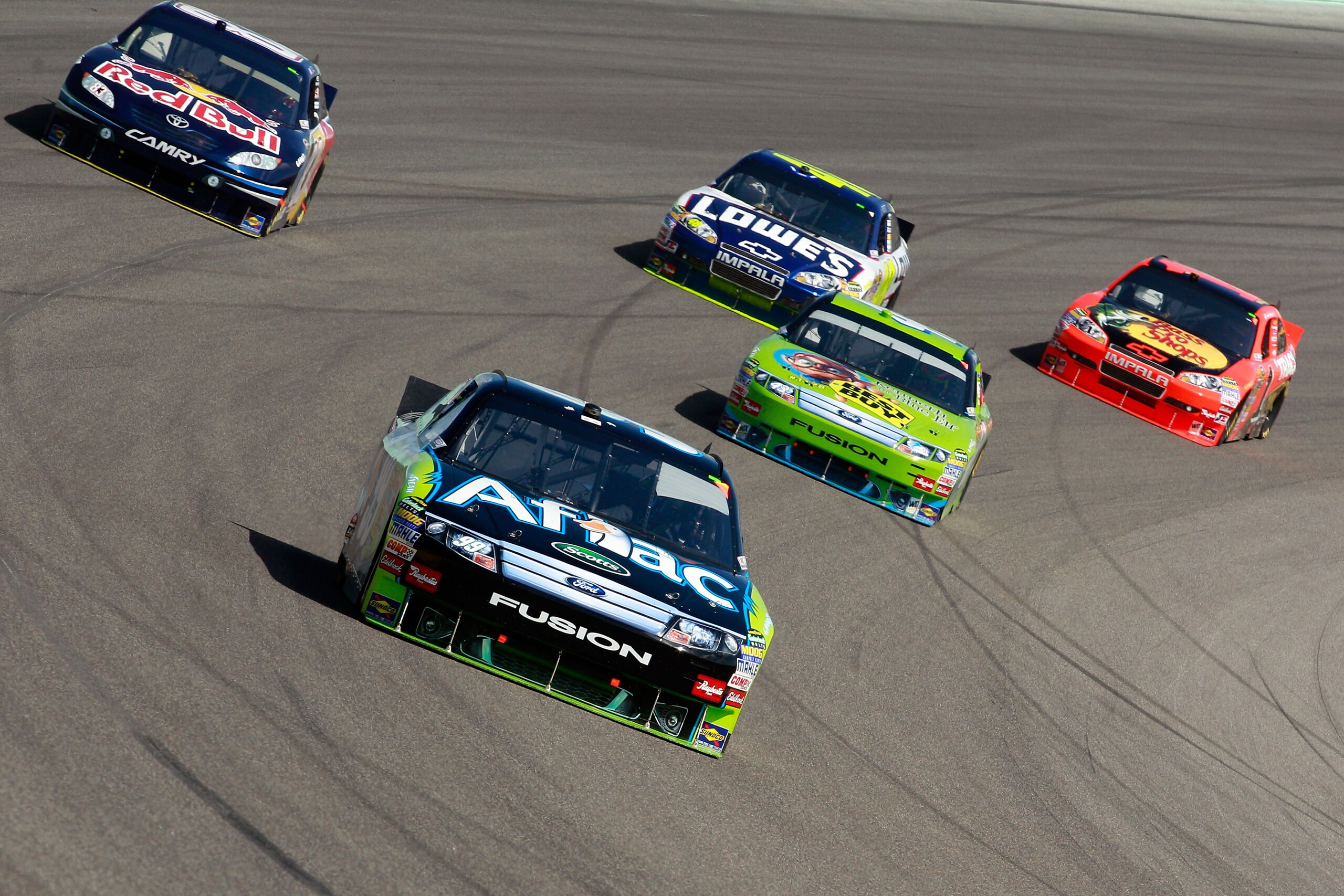 HOMESTEAD, FL - NOVEMBER 21:  Carl Edwards, driver of the #99 Aflac Ford, leads a pack of cars during the NASCAR Sprint Cup Series Ford 400 at Homestead-Miami Speedway on November 21, 2010 in Homestead, Florida.  (Photo by Sam Greenwood/Getty Images)