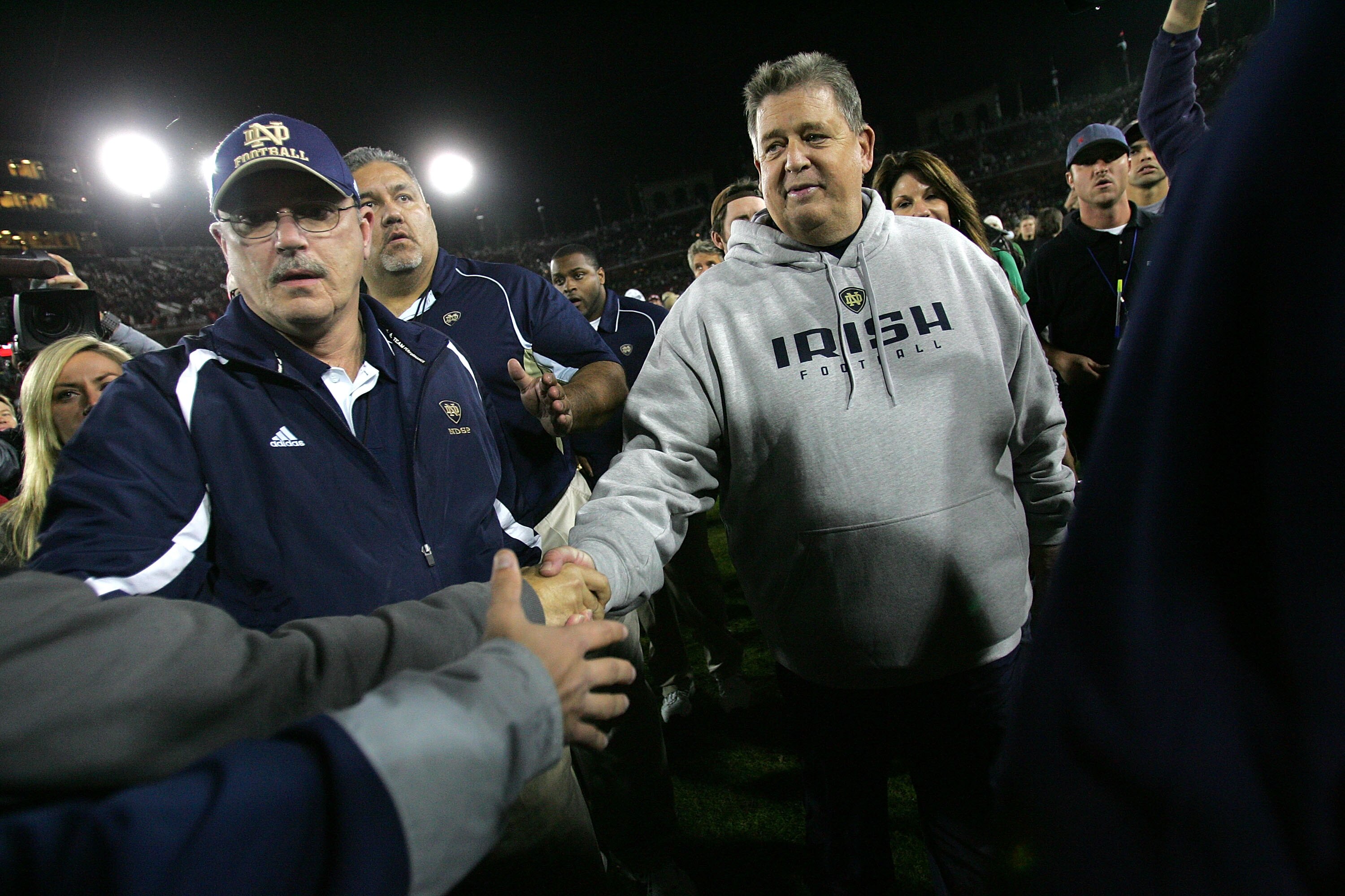 PALO ALTO, CA - NOVEMBER 28:  Notre Dame head coach Charlie Weis shakes hands with fans as he walks off the field after their loss to the Stanford Cardinal at Stanford Stadium on November 28, 2009 in Palo Alto, California.  (Photo by Ezra Shaw/Getty Image