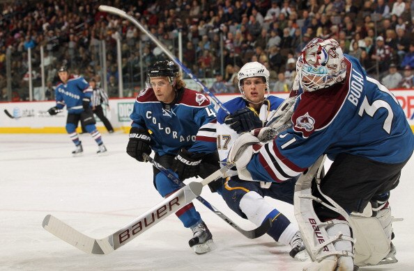 DENVER - NOVEMBER 15:  Goalie Peter Budaj #31 of the Colorado Avalanche clears the puck as John-Michael Liles #4 defends against Vladimir Sobotka #17 of the St. Louis Blues at the Pepsi Center on November 15, 2010 in Denver, Colorado. The Avalanche defeat