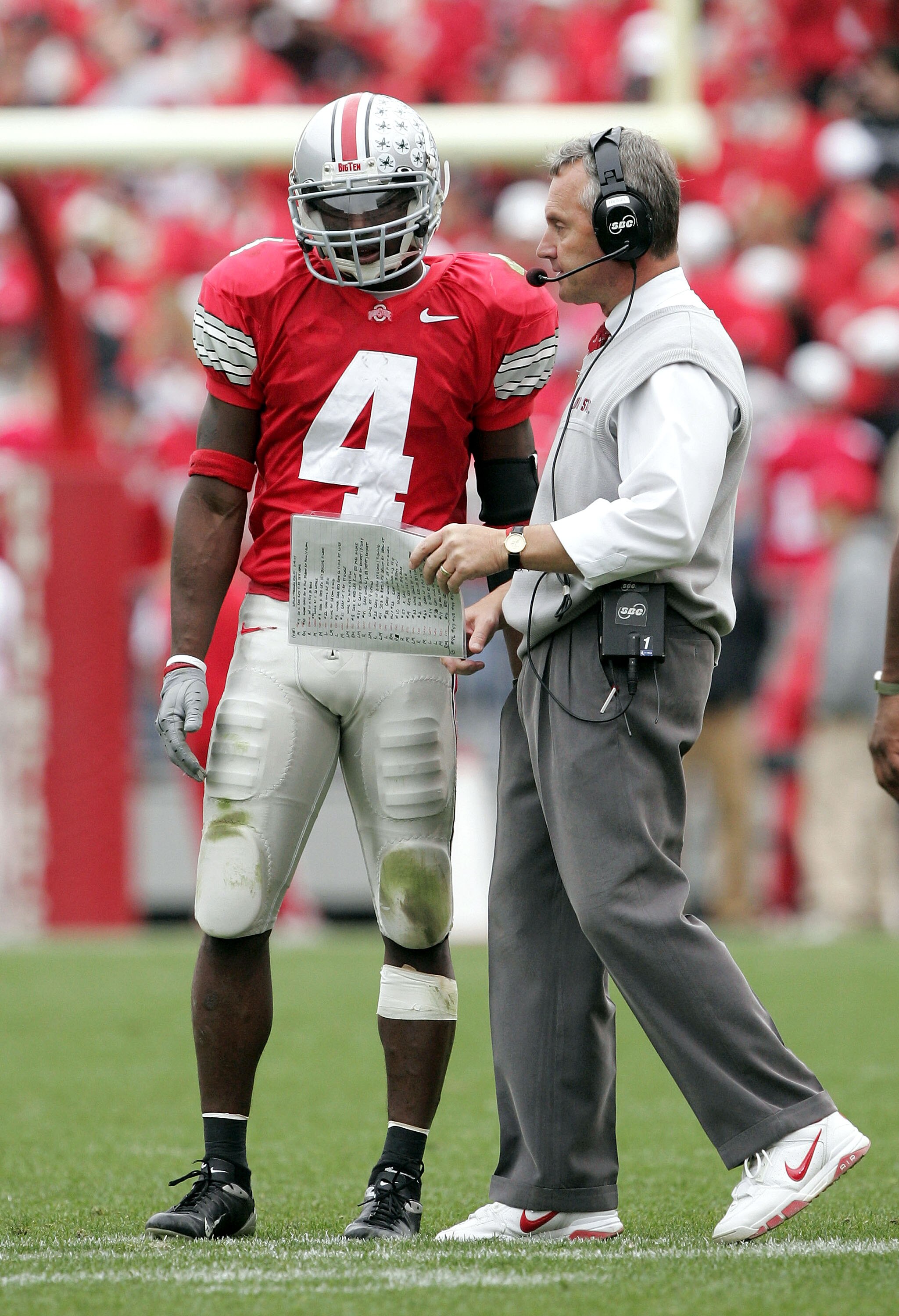 COLUMBUS, OH - NOVEMBER 20:  Head coach Jim Tressel talks with wide receiver Santonio Holmes #4 of the Ohio State Buckeyes during a break in play against the Michigan Wolverines on November 20, 2004 at Ohio Stadium in Columbus, Ohio.  Ohio State upset Mic