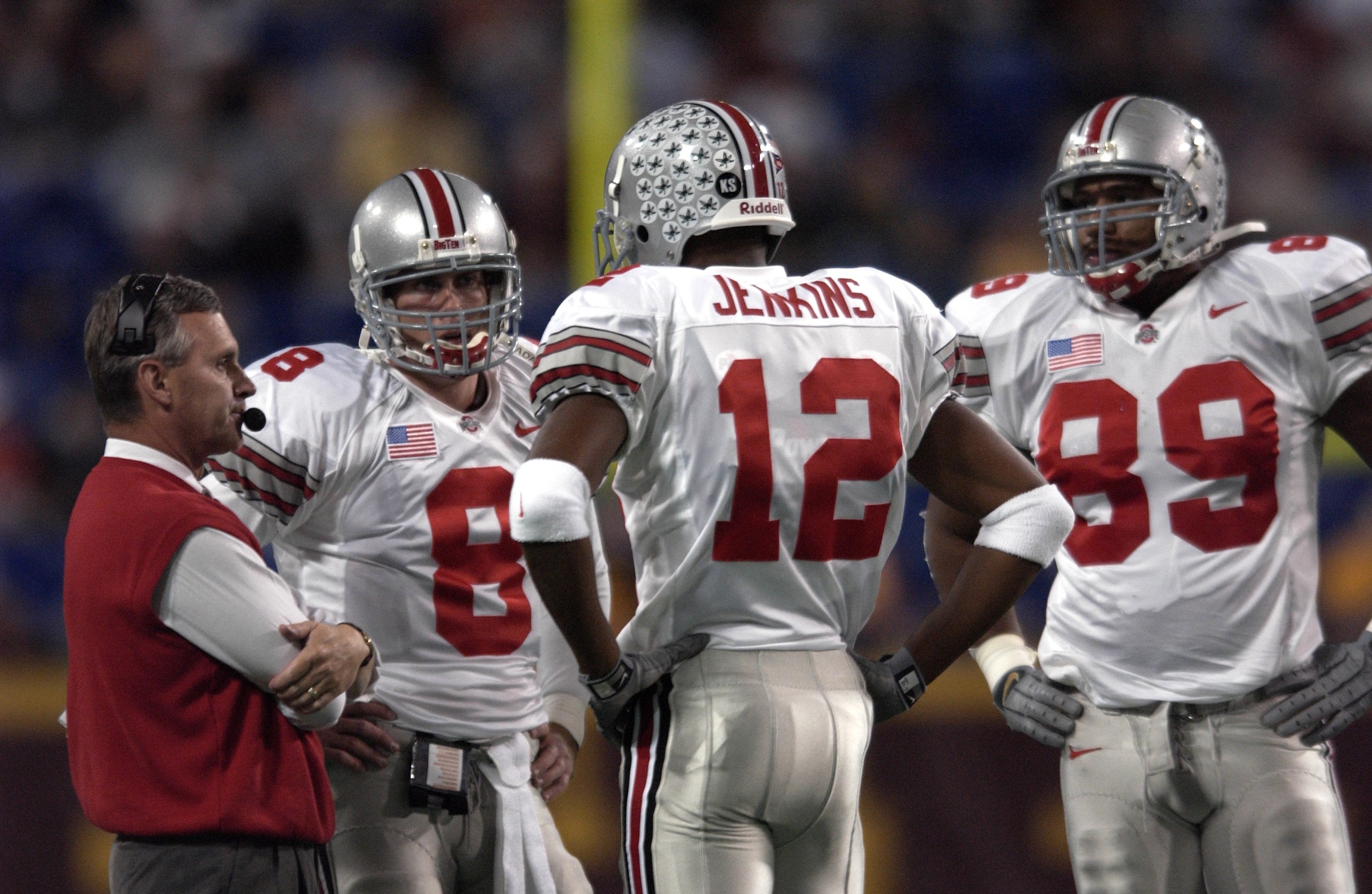 03 Nov 2001 : Head coach Jim Tressel of Ohio State talks with quarterback Steve Bellisari #8 and Michael Jenkins #12 during the game at Hubert H. Humphrey Metrodome in Minneapoils, Minnesota. The Ohio State Buckeyes beat the Minnesota Gophers 31-28. DIGIT