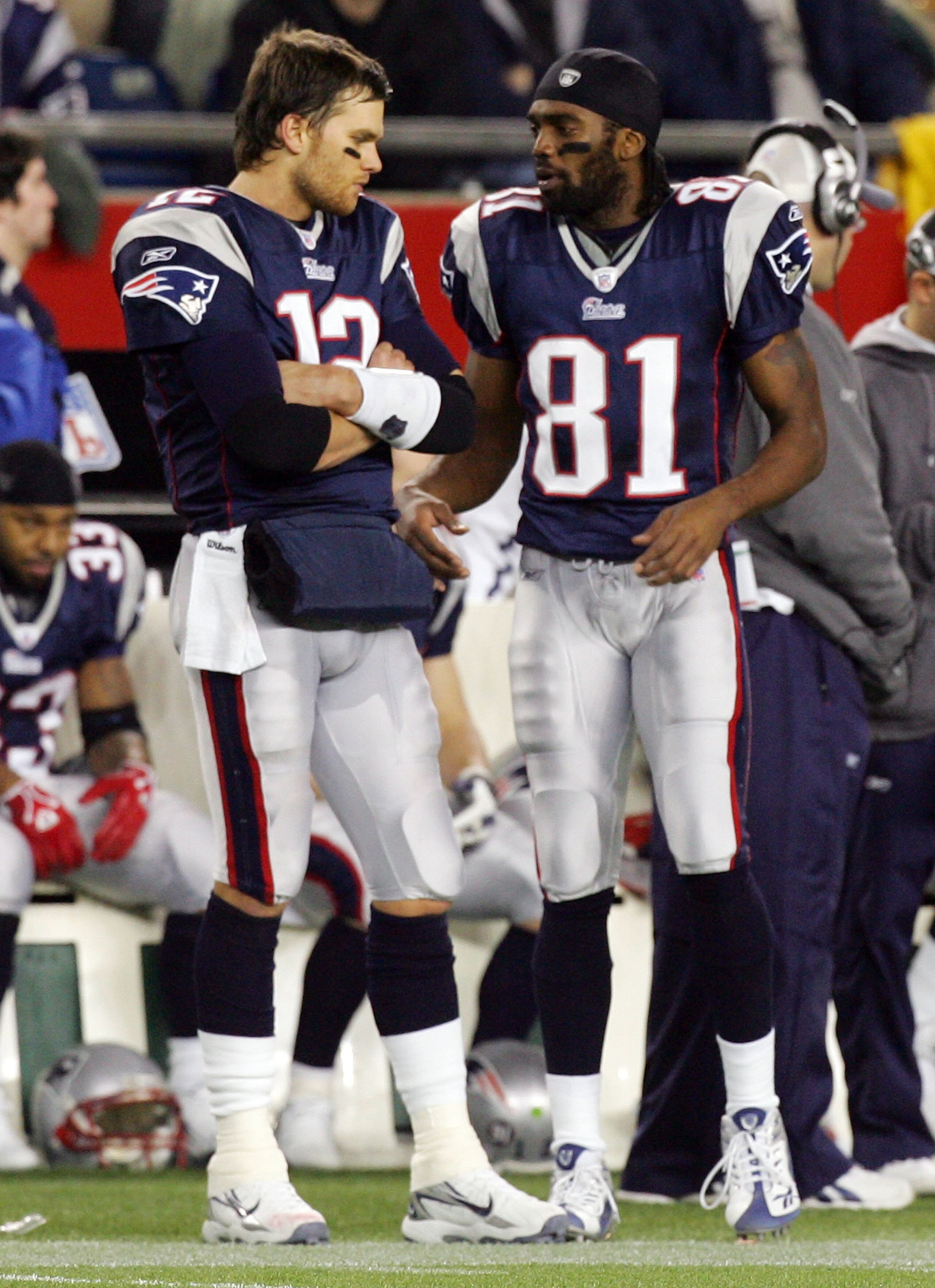 FOXBORO, MA - DECEMBER 23:  Randy Moss #81 and Tom Brady #12 of the New England Patriots talk on the sideline during a timeout against the Miami Dolphins during their game at Gillette Stadium on December 23, 2007 in Foxboro, Massachusetts.  (Photo by Jim
