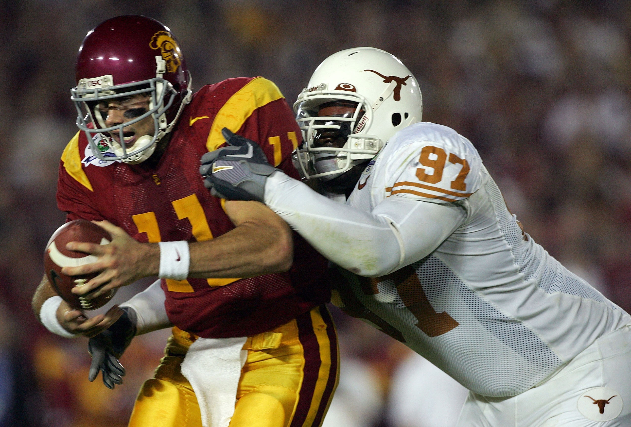 PASADENA, CA - JANUARY 04:  Quarterback Matt Leinart #11 of the USC Trojans is sacked by Frank Okam #97 of the Texas Longhorns during the second quarter of the BCS National Championship Rose Bowl Game at the Rose Bowl on January 4, 2006 in Pasadena, Calif